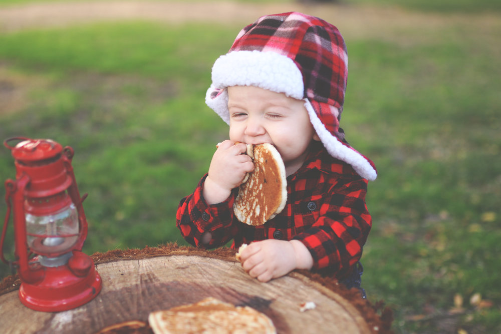 kid dressed in flannel eating a pancake