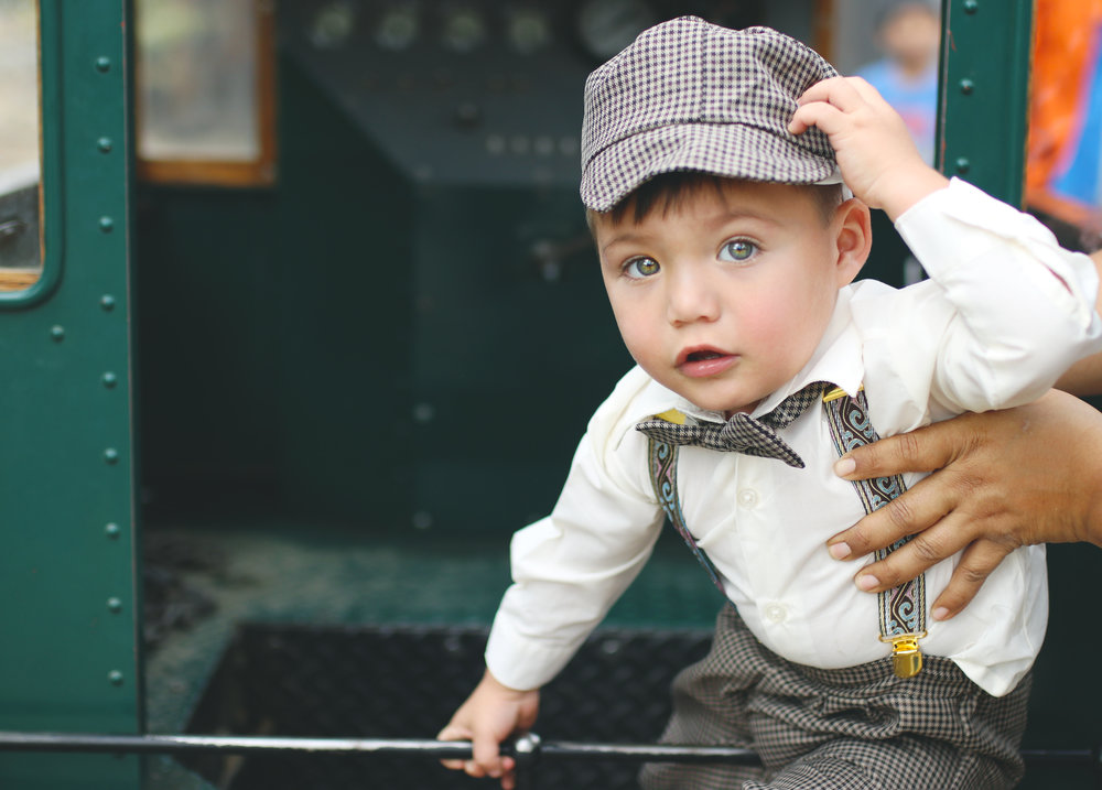 baby boy dressed as a train conductor