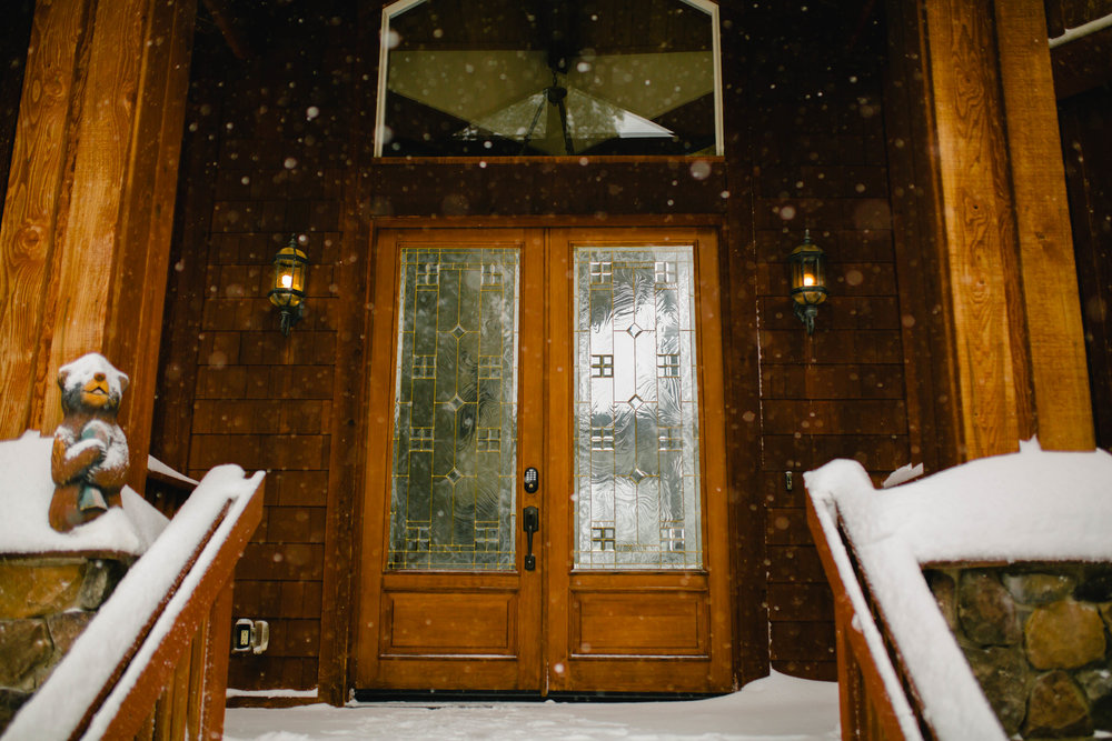 front door of a cabin in the snow during a winter wedding