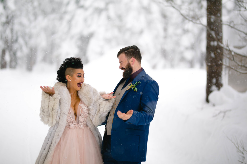 candid photo of a bride and groom during snowy wedding photos