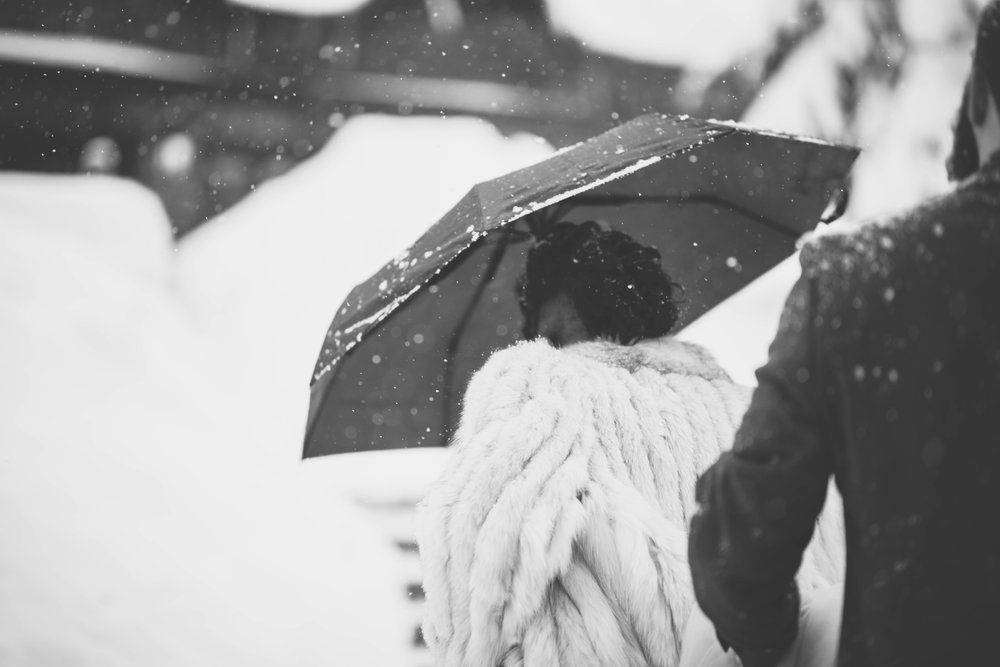 black and white photo of the bride and groom in the snow