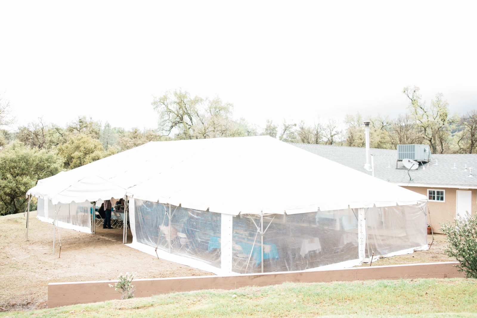 white wedding tent for a rainy day outdoor wedding