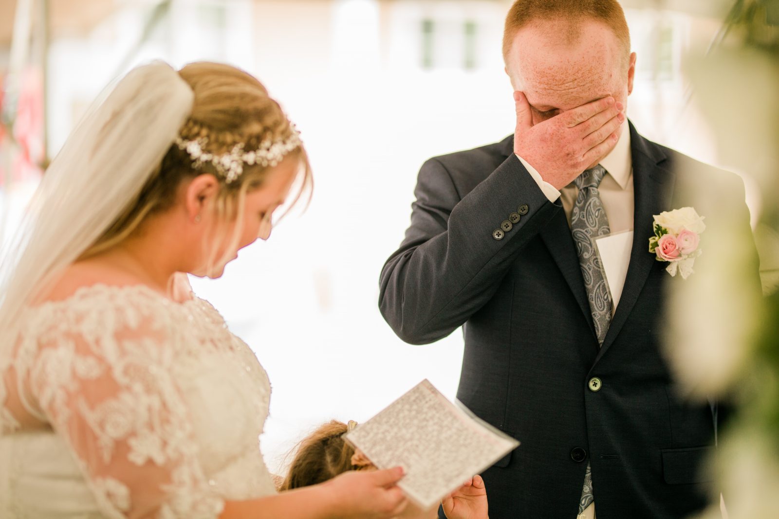 groom crying as the bride reads her wedding vows
