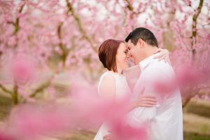 peach blossom engagement photos with white dresses