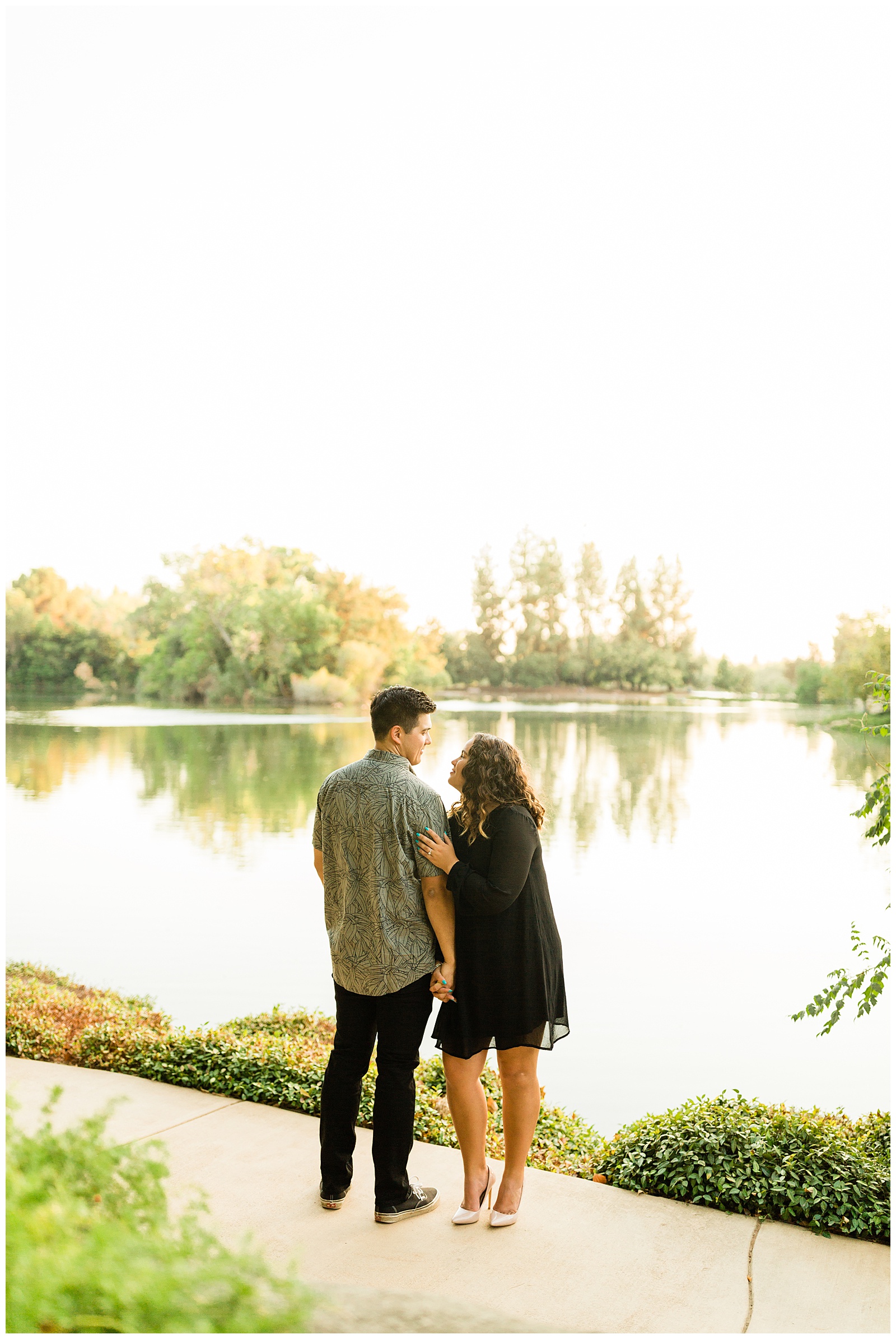 couple overlooking the pond at woodward park in fresno