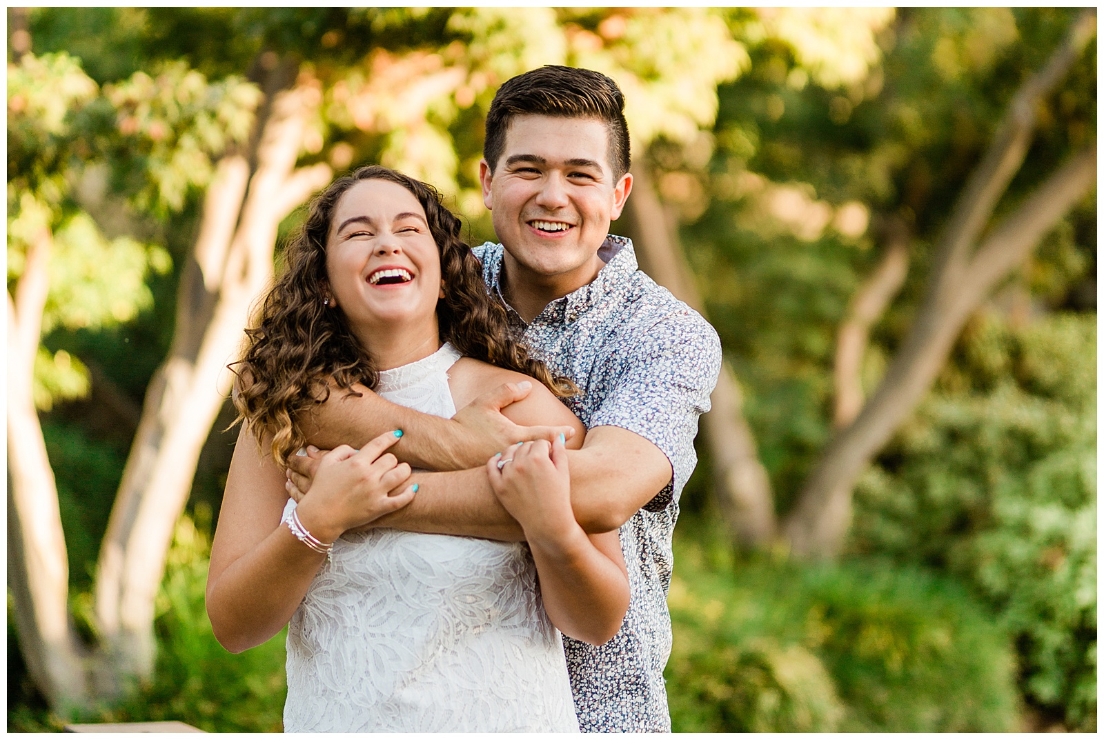 newly engaged couple laughing during a sunset photo shoot by megan helm photography fresno wedding photographer