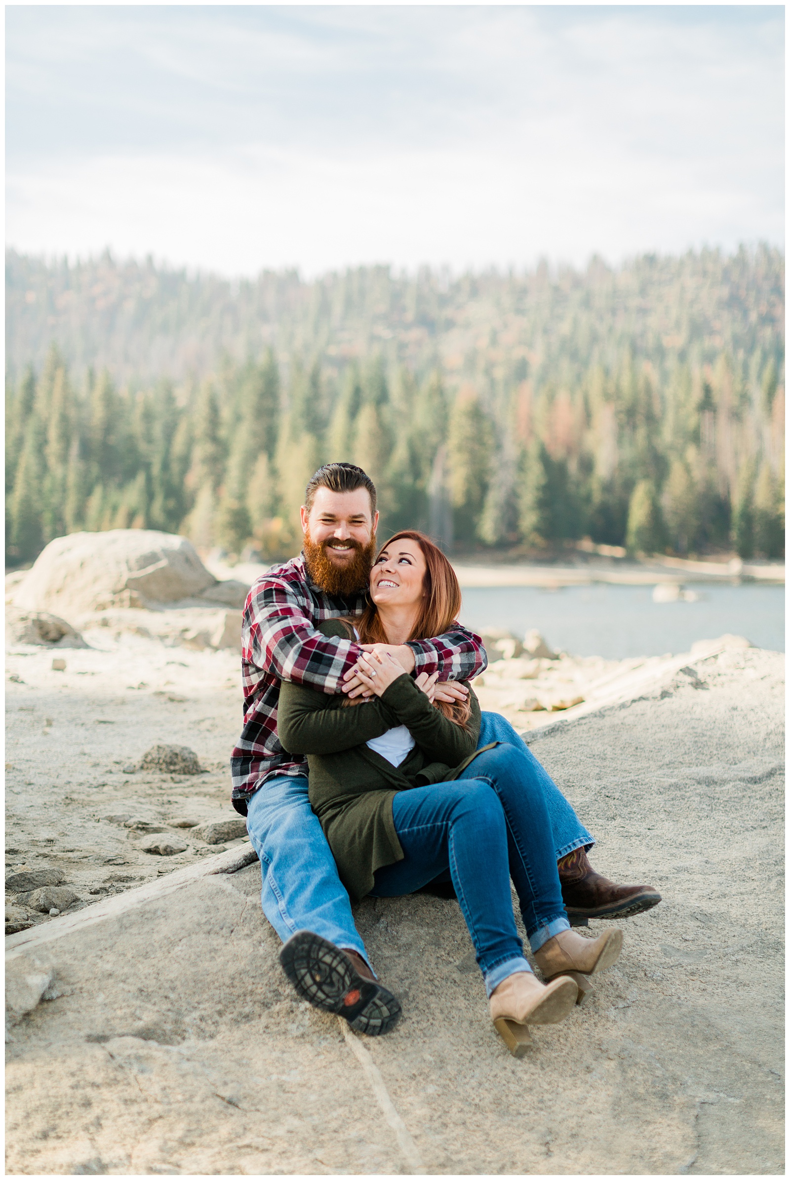 couple hugging on a rock by shaver lake
