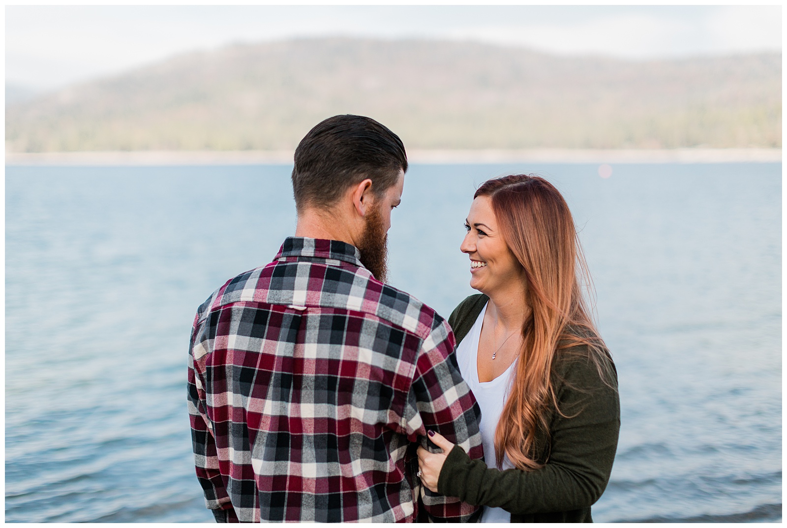 newly engaged couple smiling by shaver lake