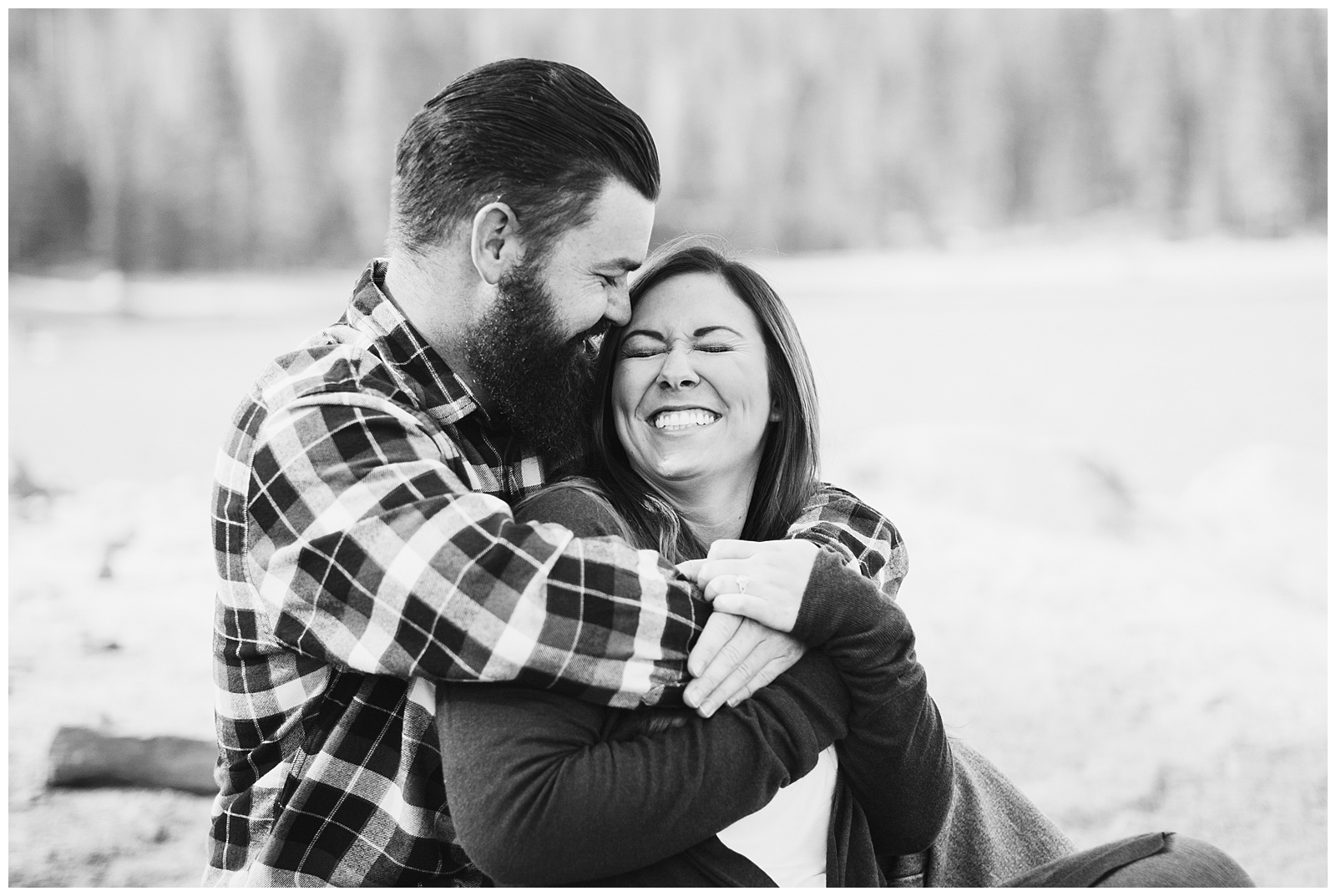 black and white photo of a couple laughing during an engagement photo shoot at shaver lake