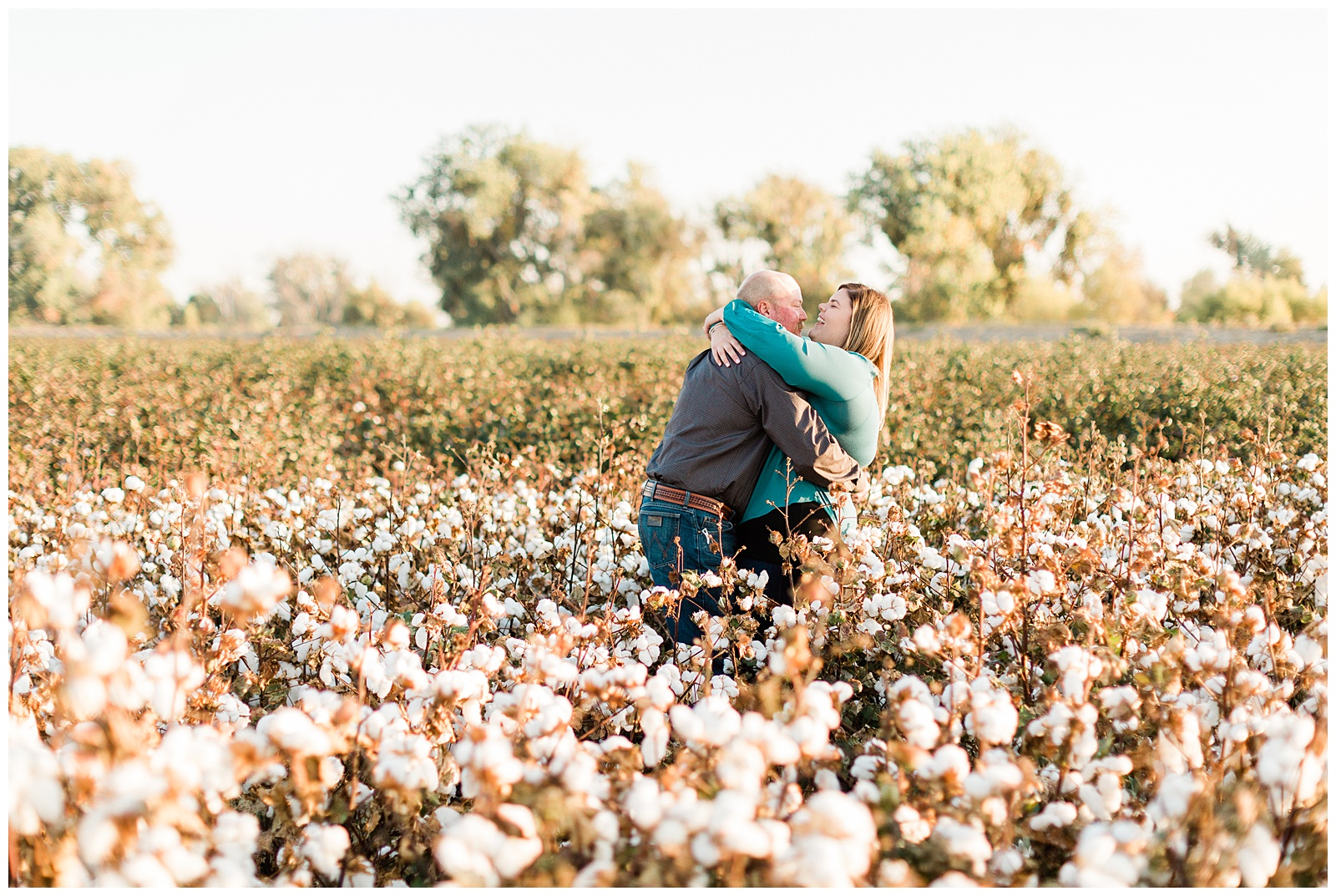 candid engagement photos in a cotton field