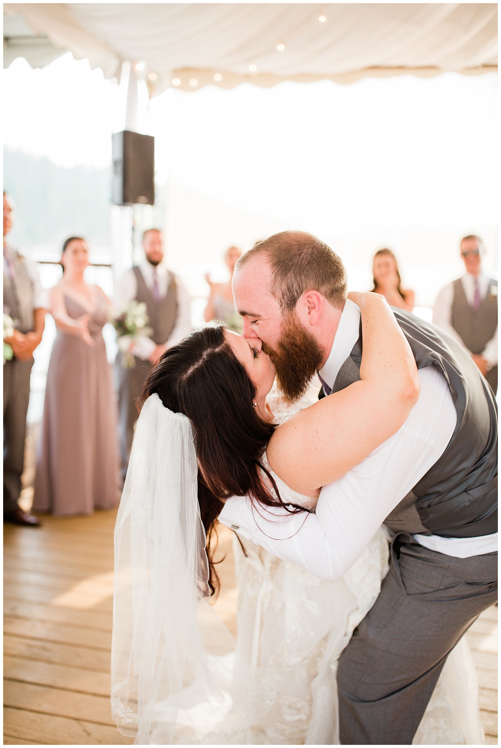 groom kissing the bride during their first dance