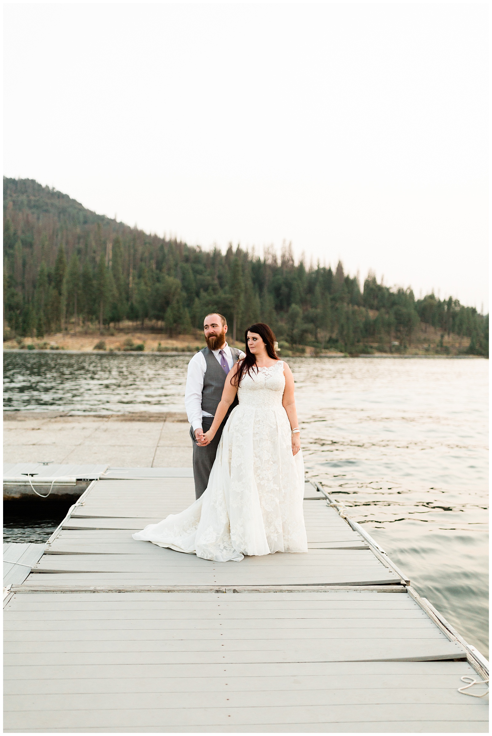 bride and groom taking sunset portraits on the docks at the pines resort in bass lake