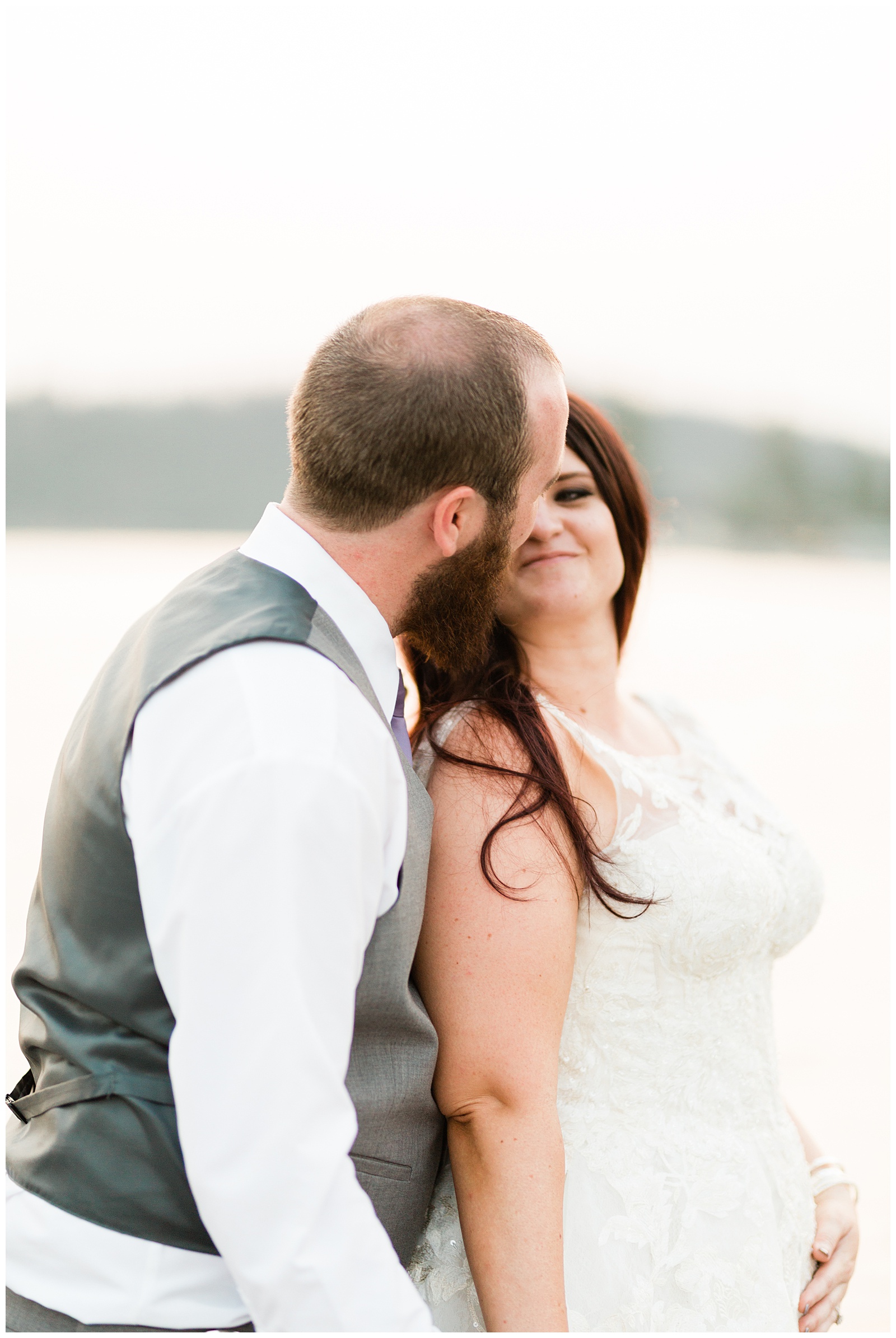 bride smiling at her groom during sunset portraits on the docks at the pines resort in bass lake