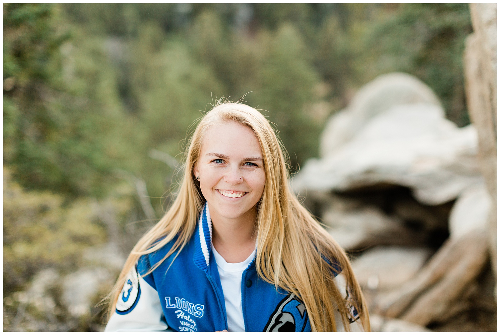graduate smiling during an outdoor senior portrait session at the palm springs aerial tramway