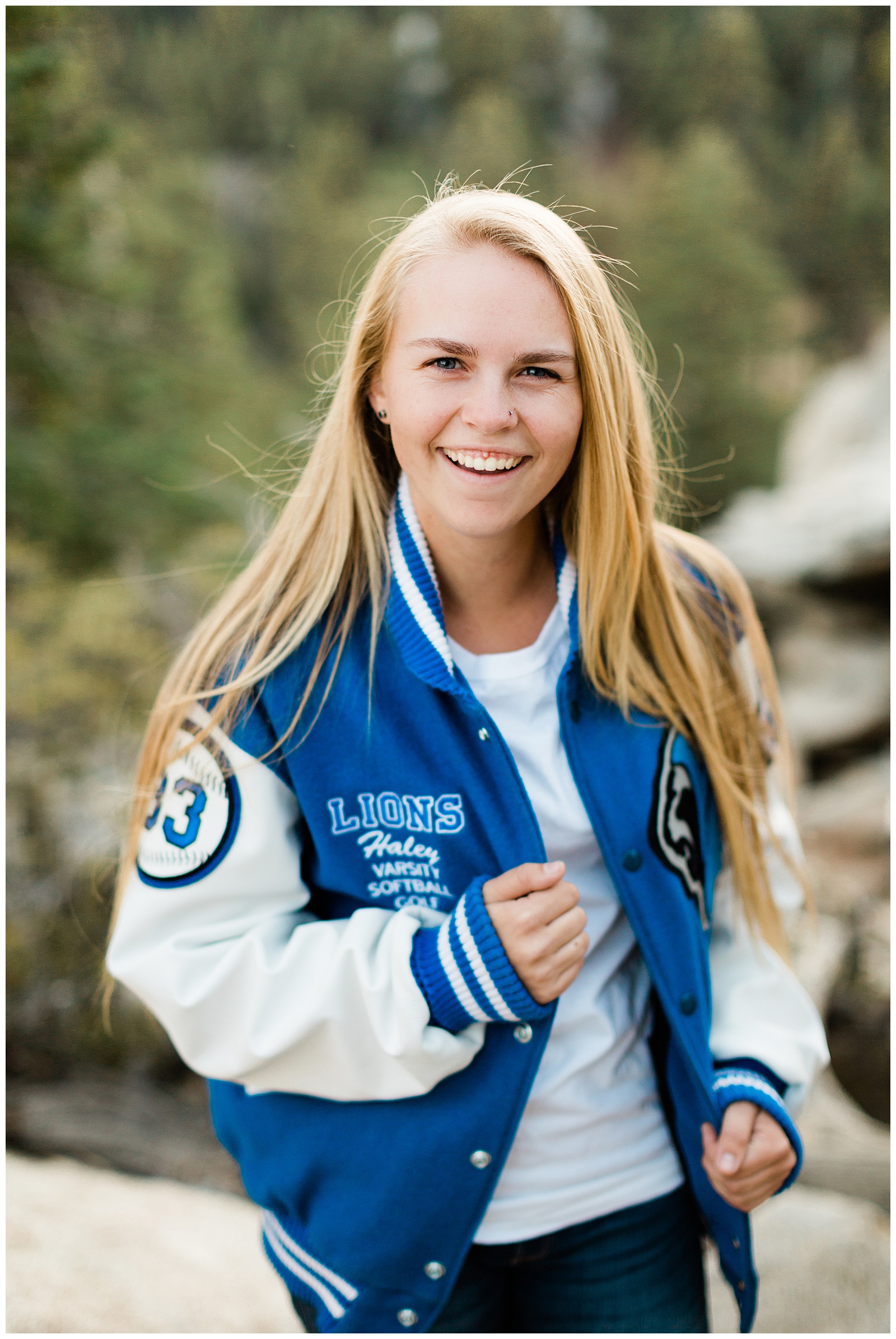 outdoor senior girl portraits in the mountains with high school letterman jacket
