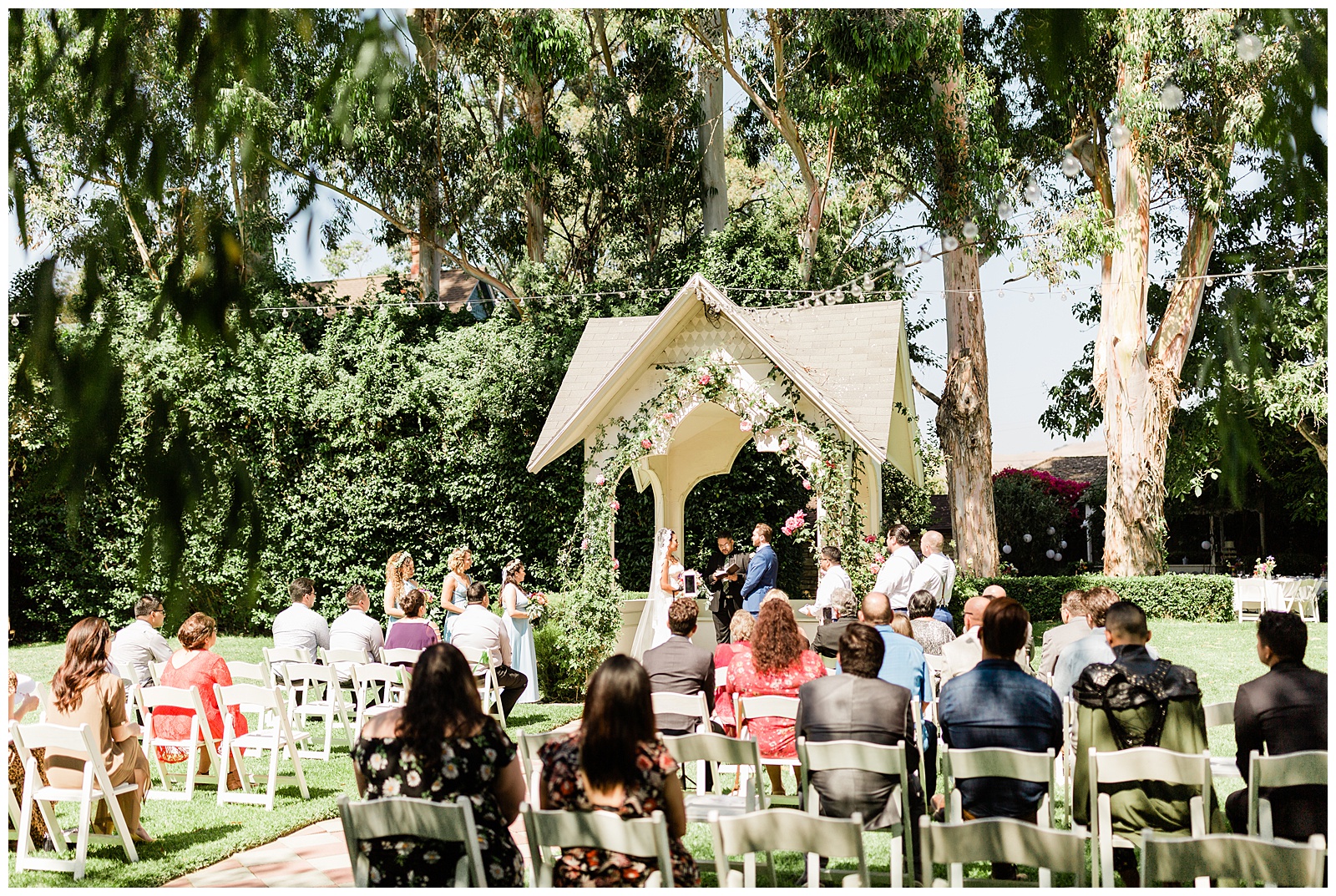 wide shot of the wedding ceremony at the kaleidoscope inn and gardens in nipomo california