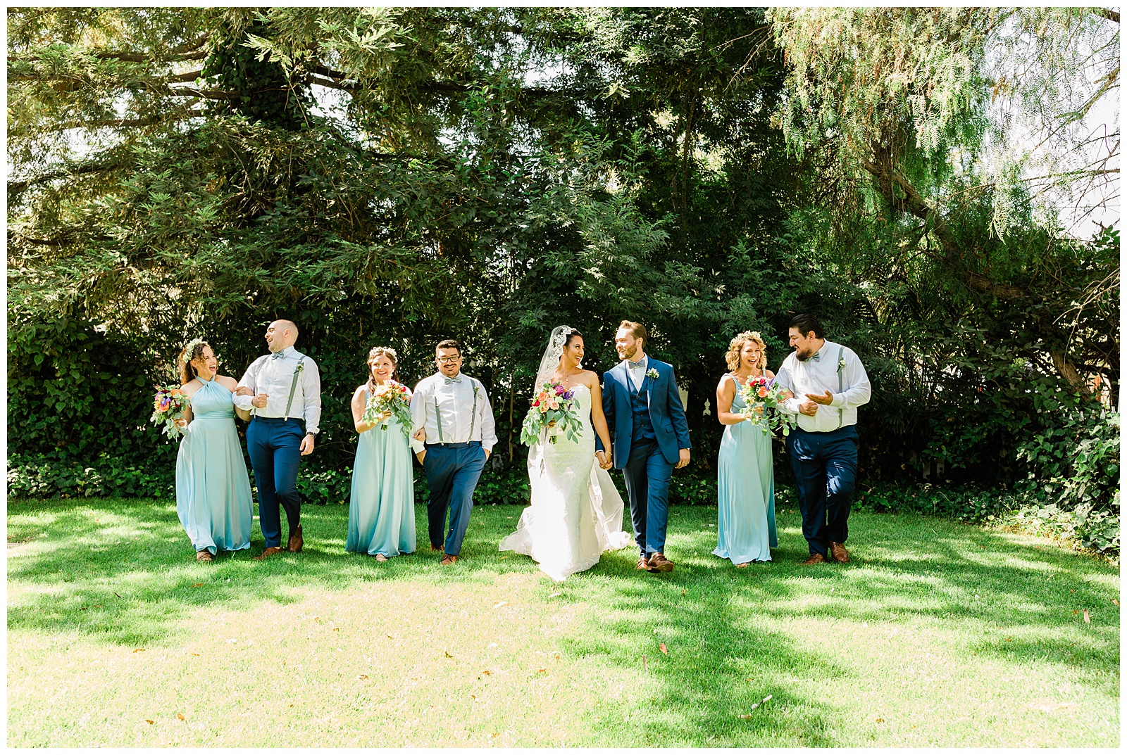 bridal party walking and laughing at the kaleidoscope inn and gardens
