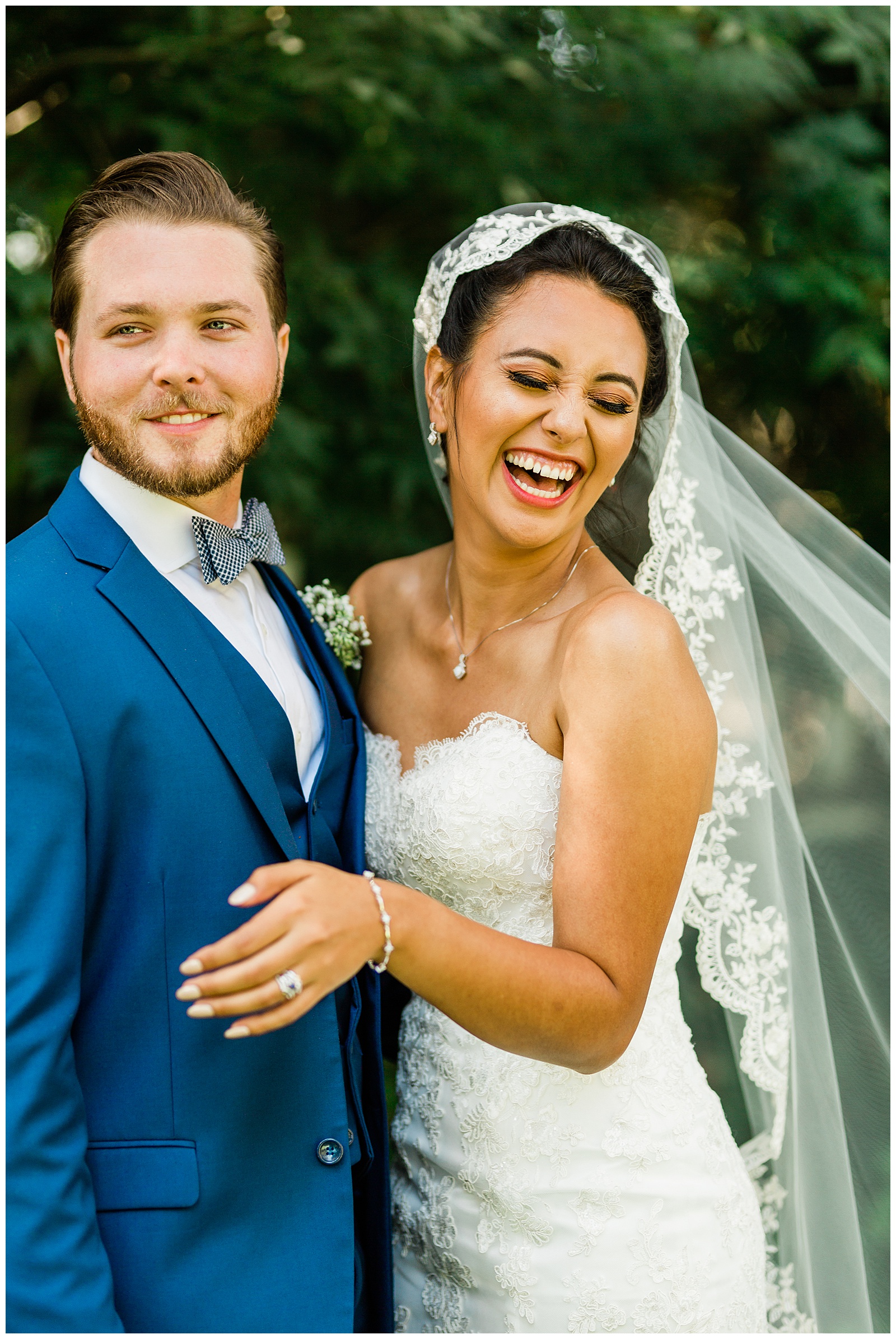 candid photo of a bride and groom laughing during wedding portraits