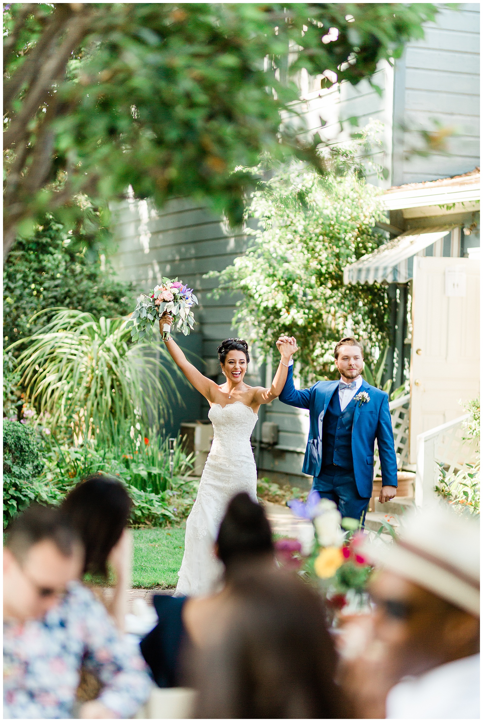 bride and groom walking into their outdoor wedding reception