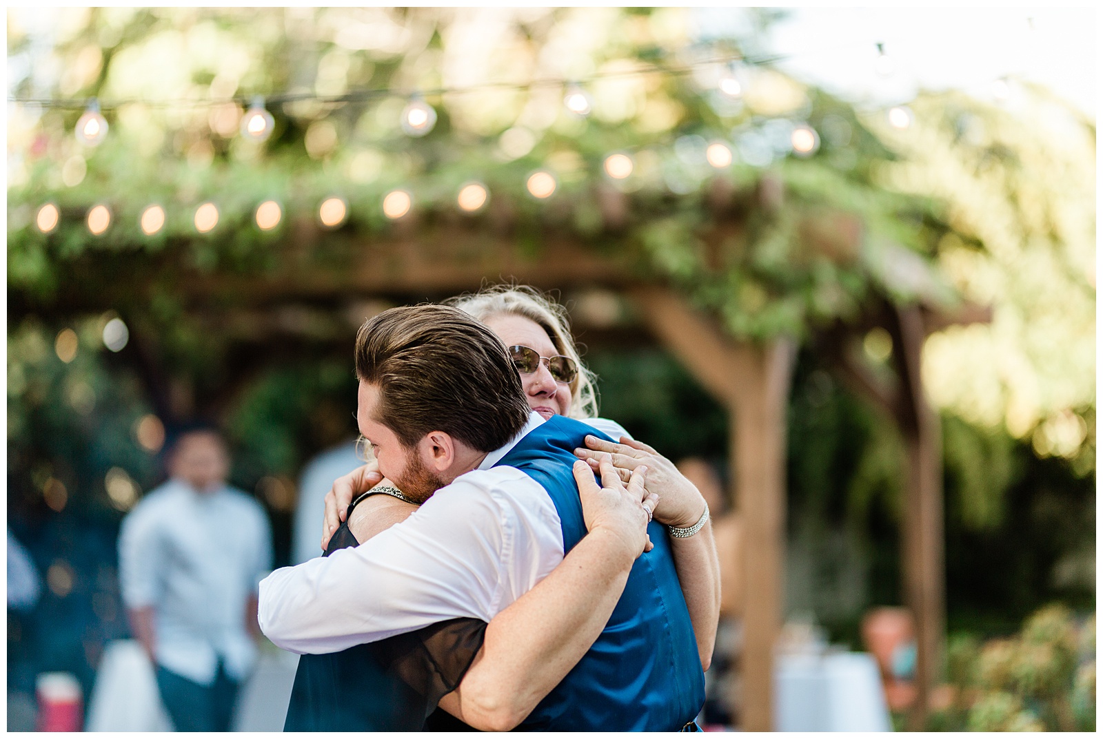 groom hugging his mother during the mother son dance