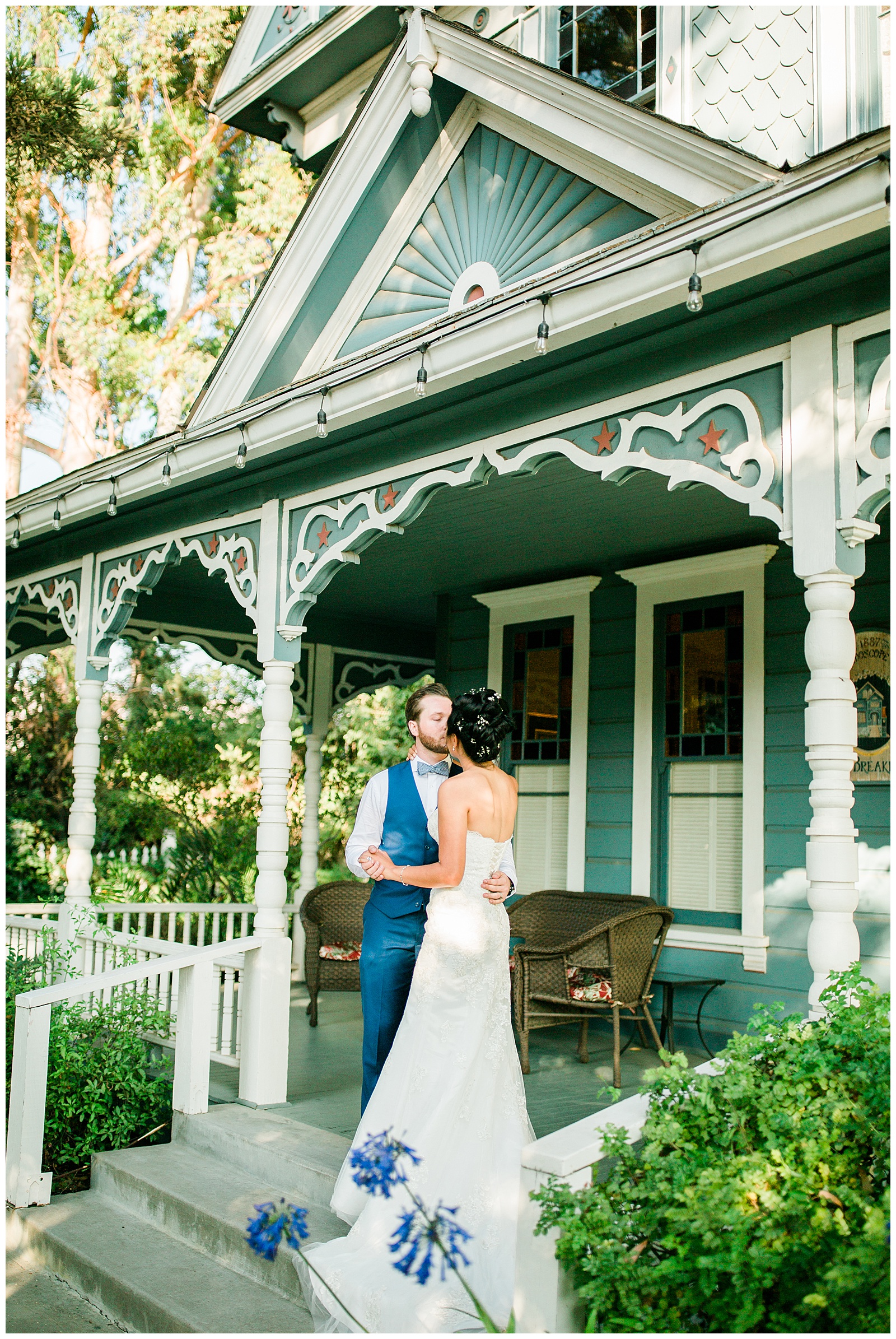 bride and groom kissing in front of the kaleidoscope inn and gardens