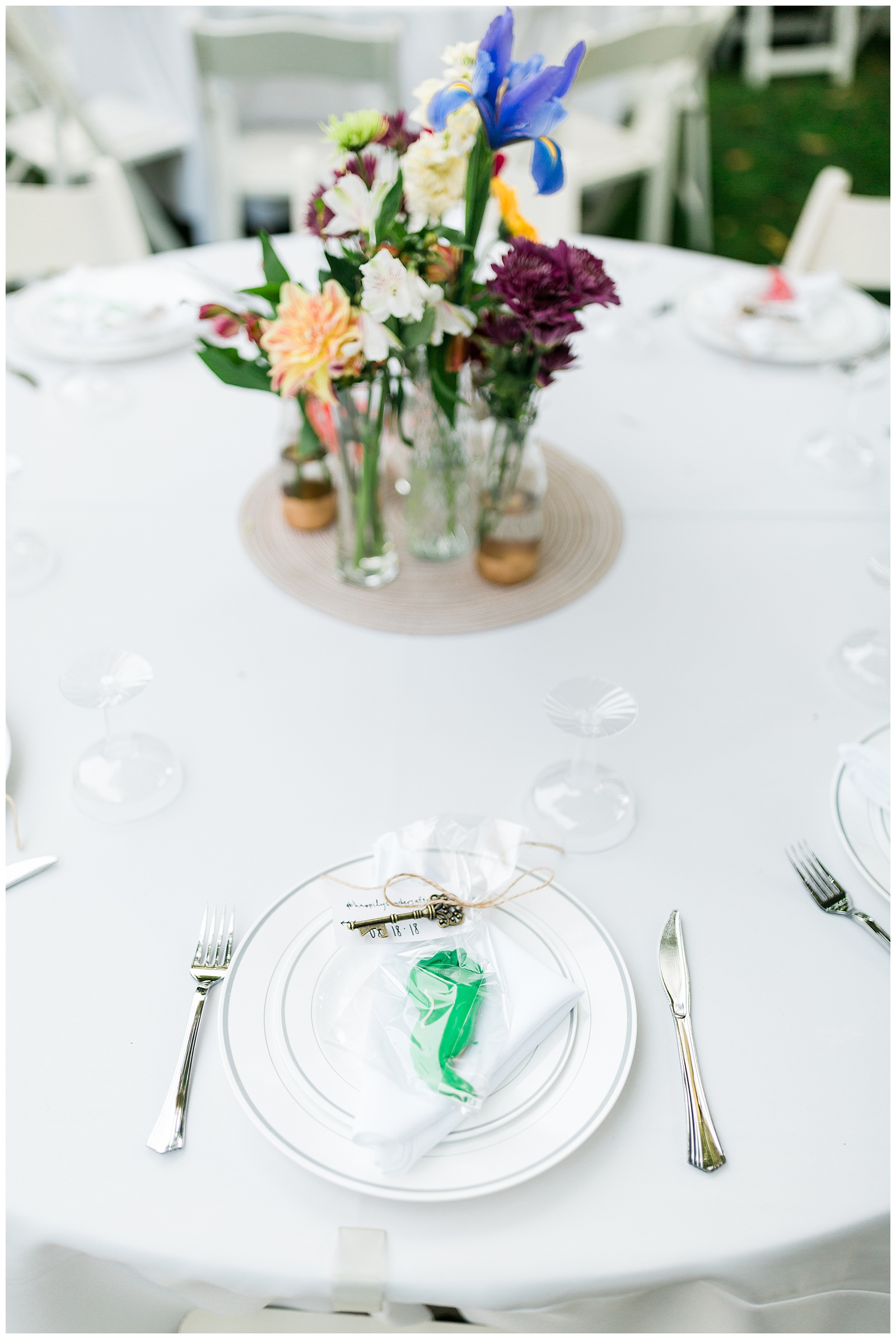 white table cloth with bright colored wedding decor and a chili pepper cookie