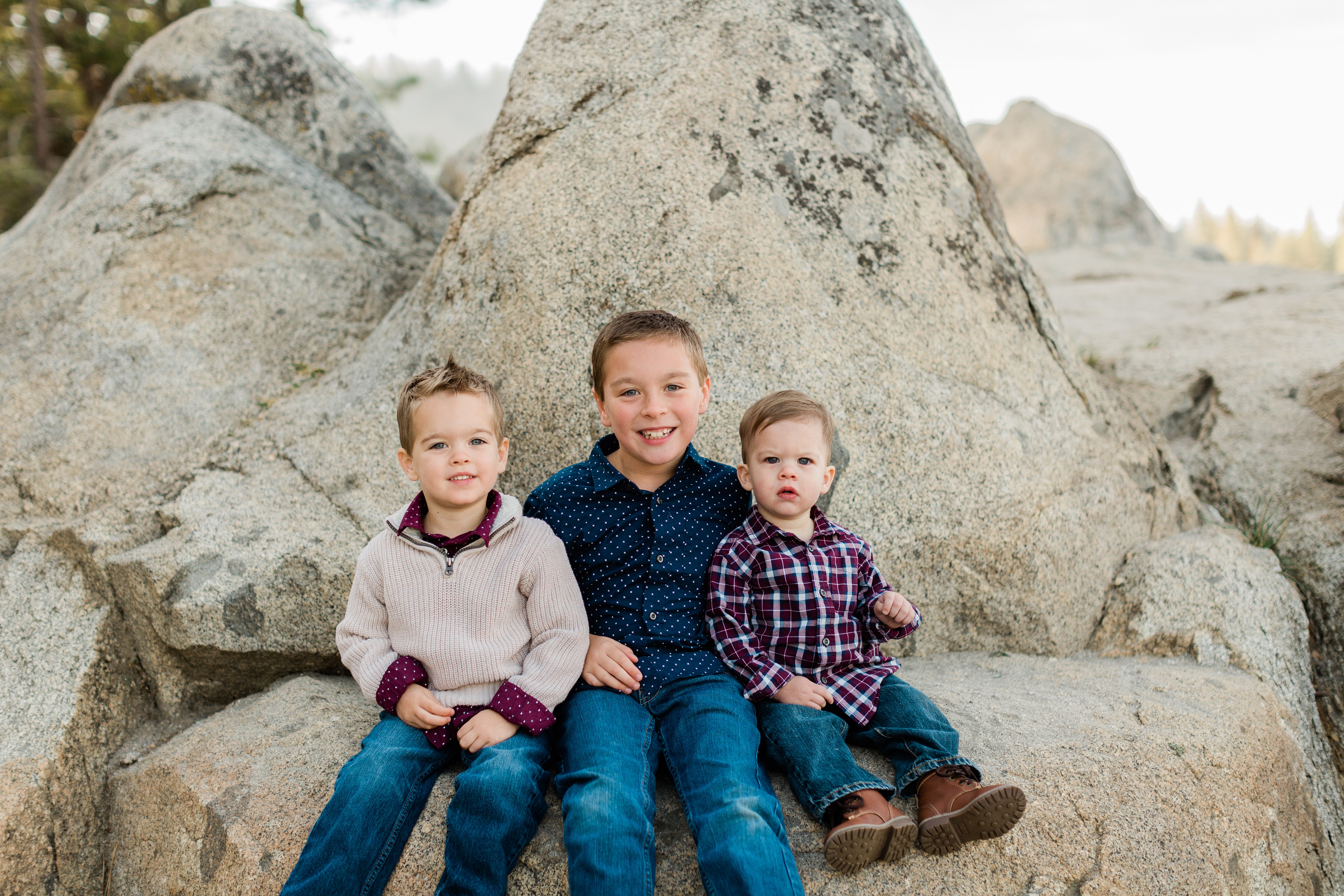navy and maroon family photo outfits of boys sitting on a rock
