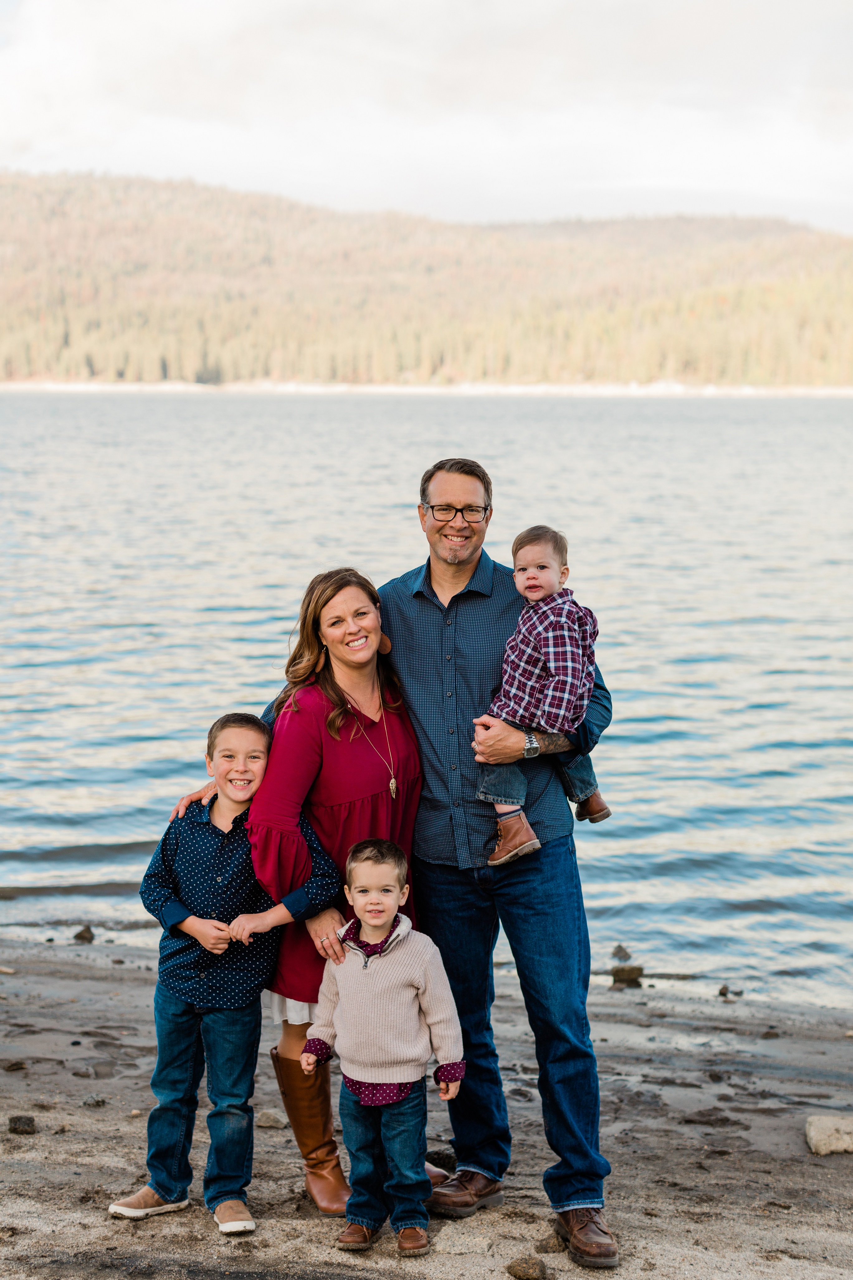 maroon and navy blue family photos by a lake