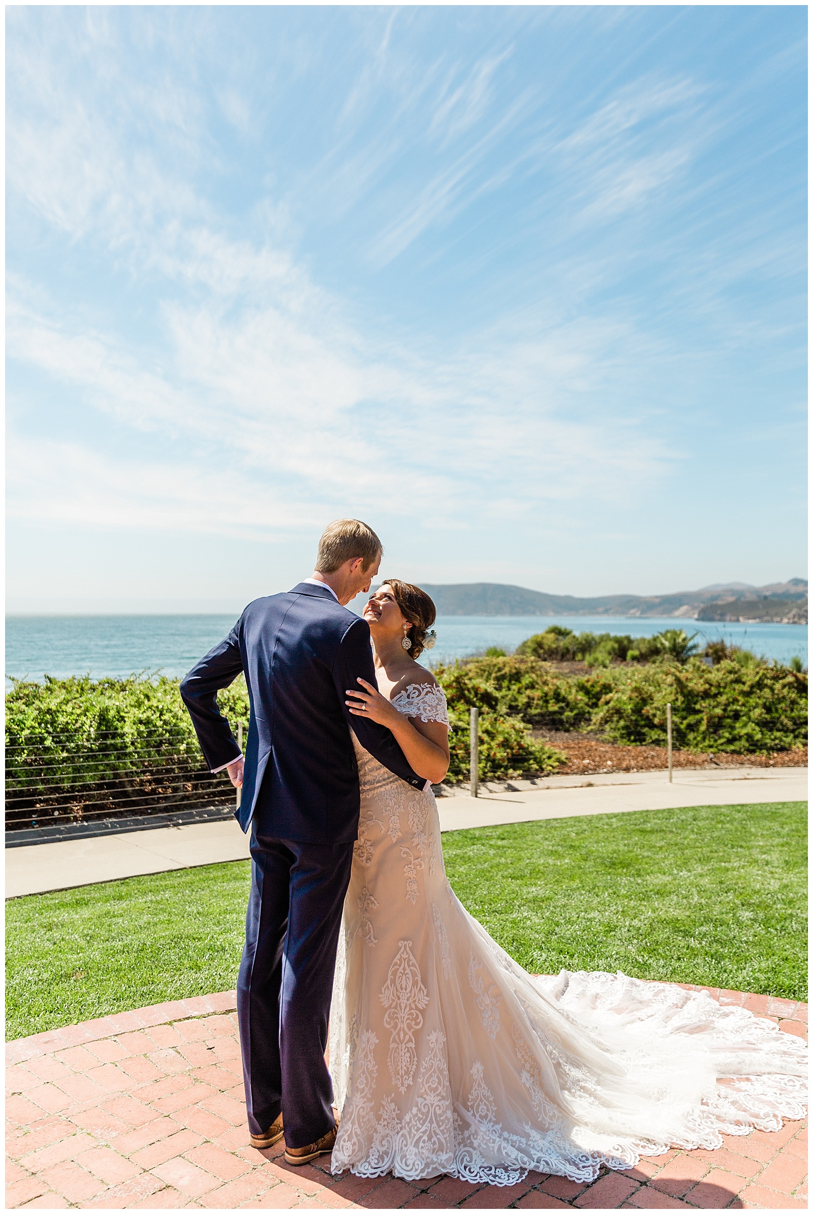 romantic photo of a bride and groom overlooking the pacific ocean