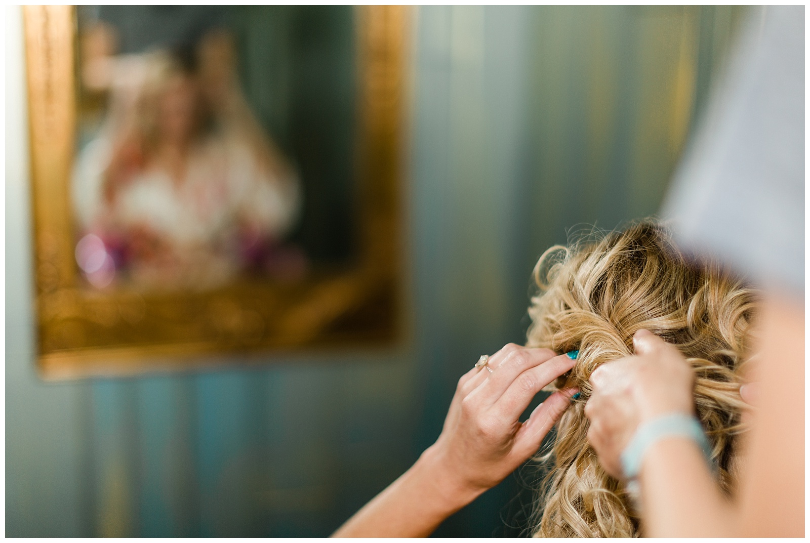 Bride getting her hair done on her wedding day