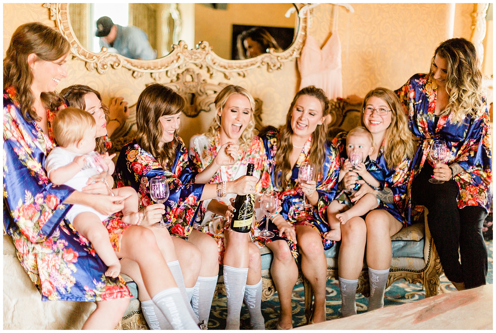 Bride and her bridesmaids celebrating with champagne before the wedding ceremony