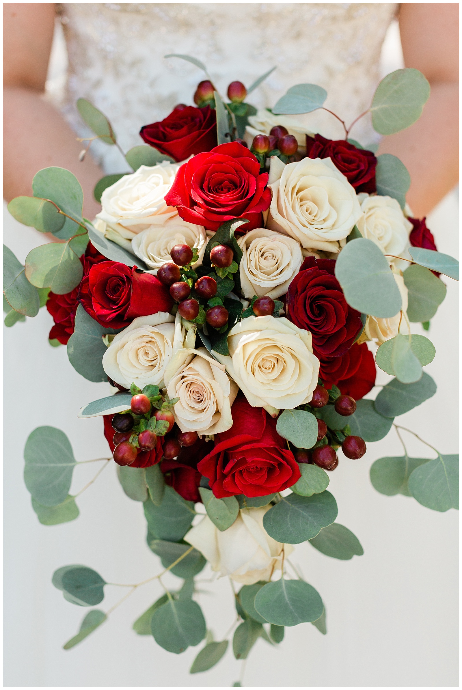 red and white wedding bouquet with eucalyptus accents