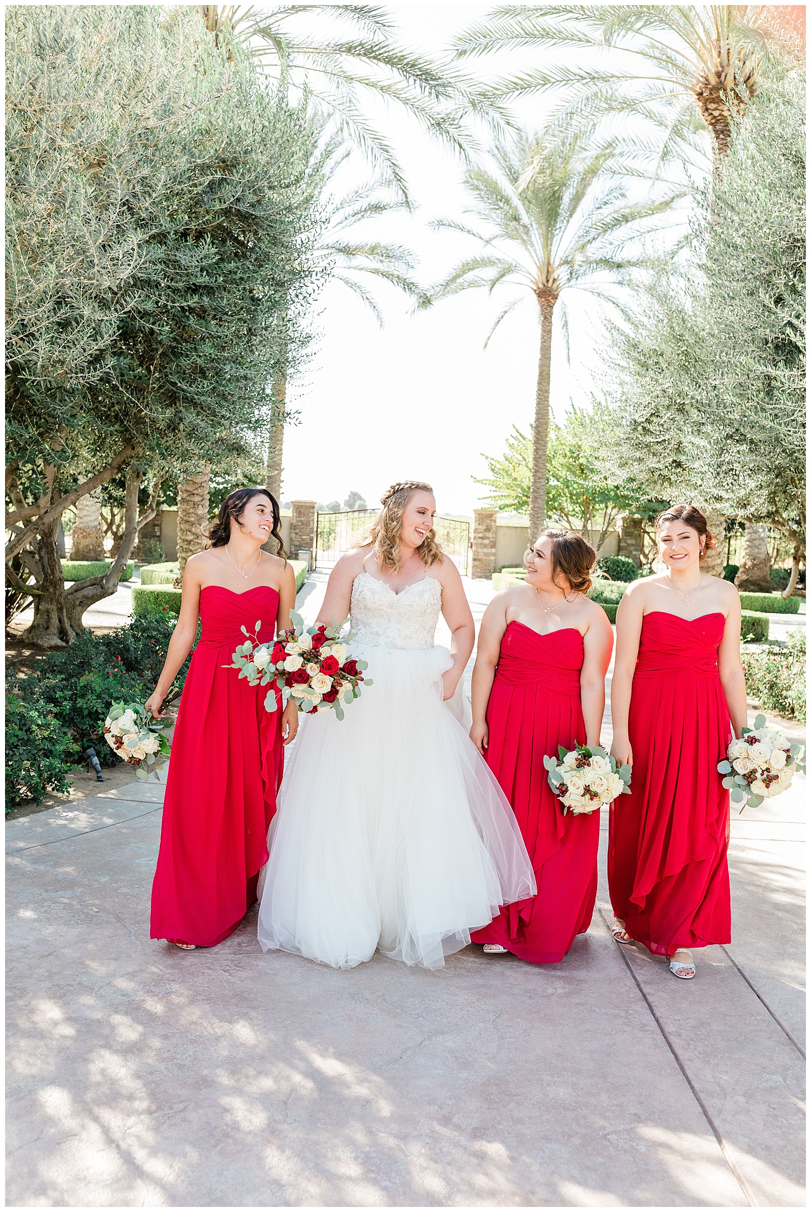 Bride and bridesmaids walking down the driveway of Tuscan Gardens Venue in Kingsburg, CA