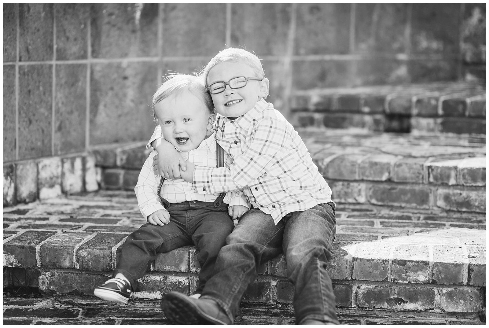 brothers hugging on brick stairs
