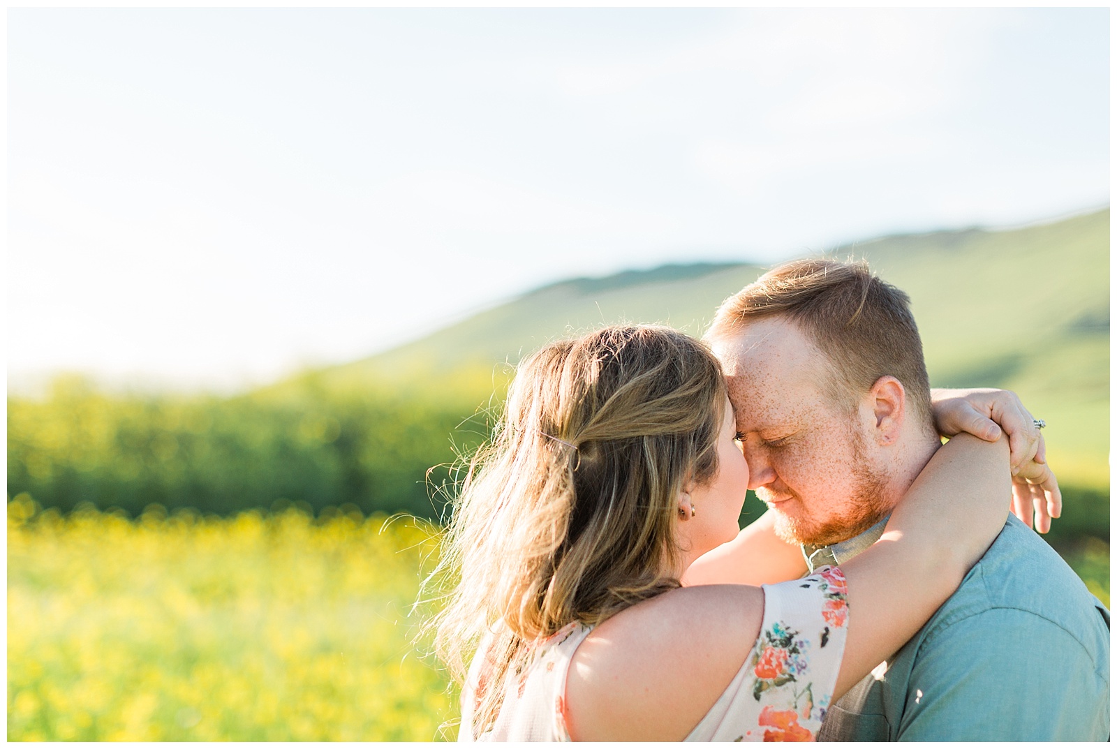 couple romantically embracing in a yellow wildflower field