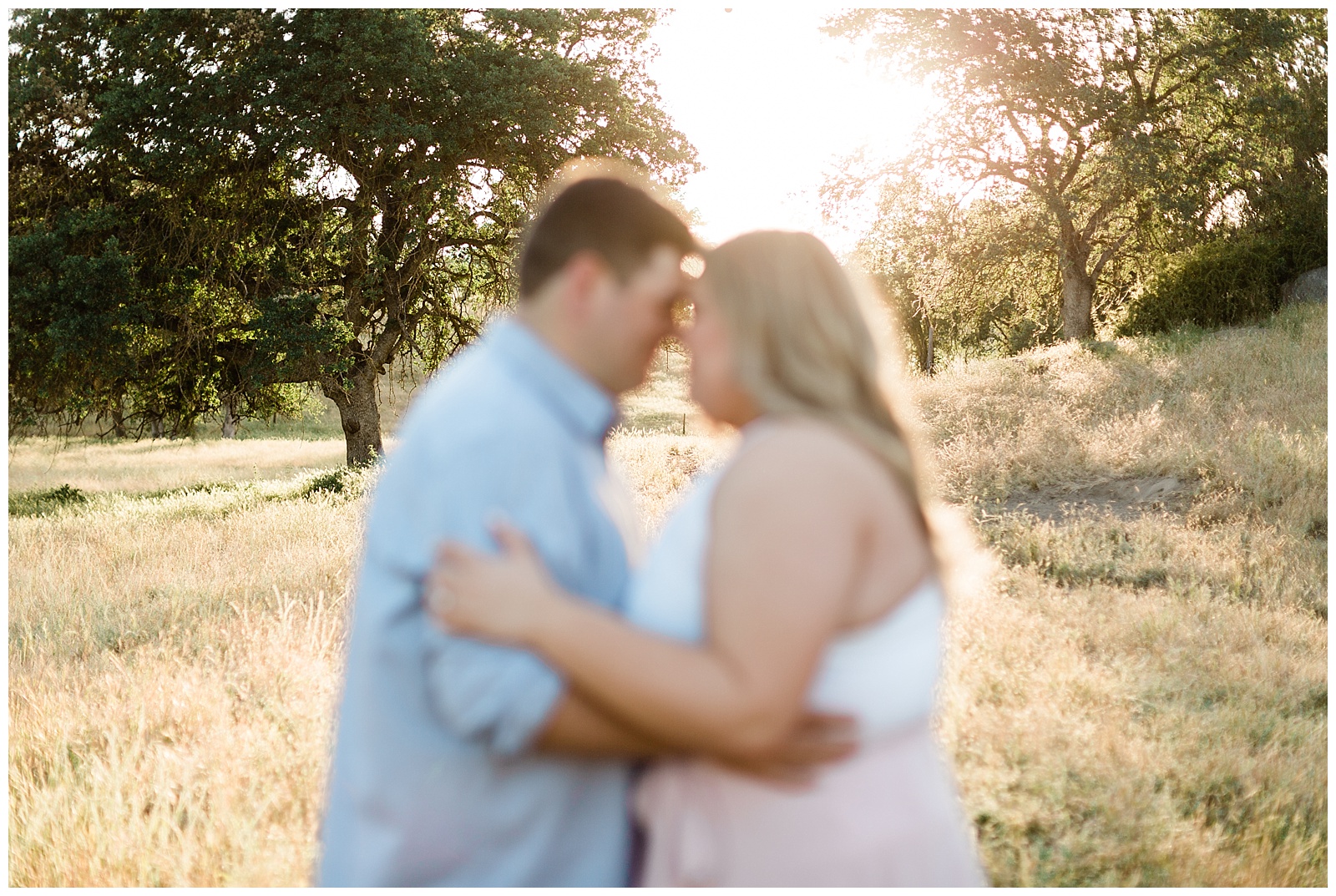 soft focus image of a newly engaged couple embracing 