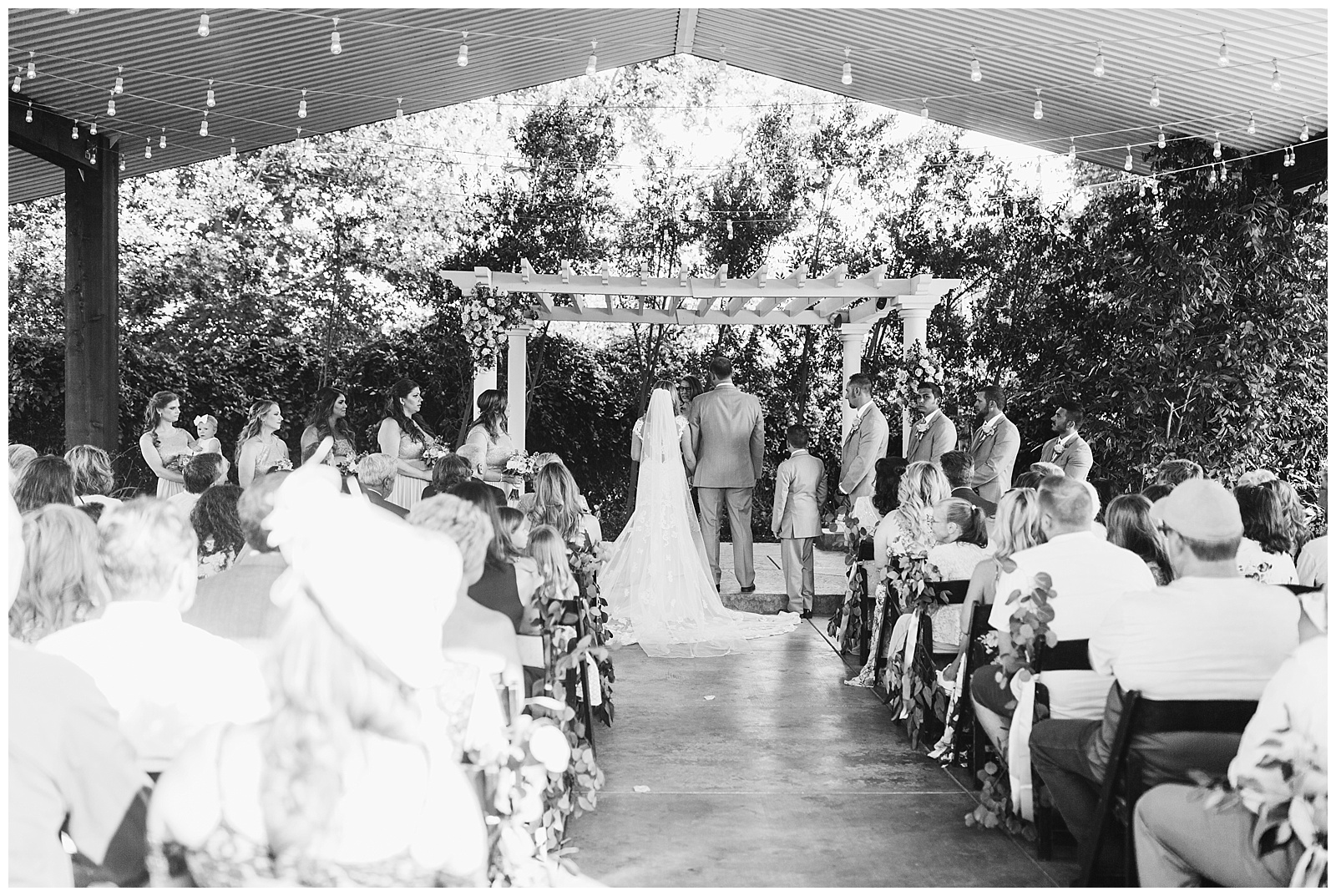 black and white pulled back photo of a wedding ceremony at seven sycamores in the barn