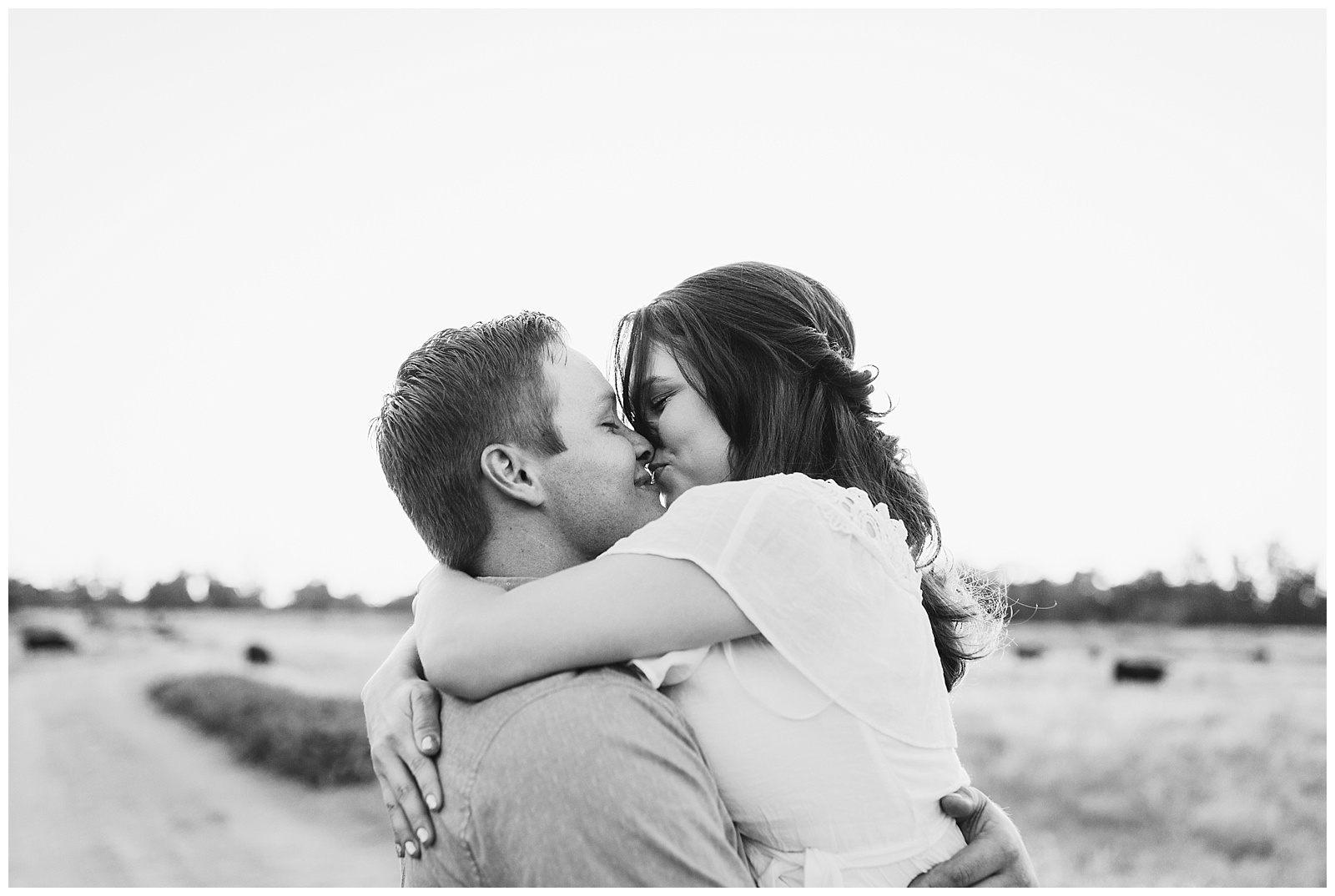 black and white photo of a couple kissing