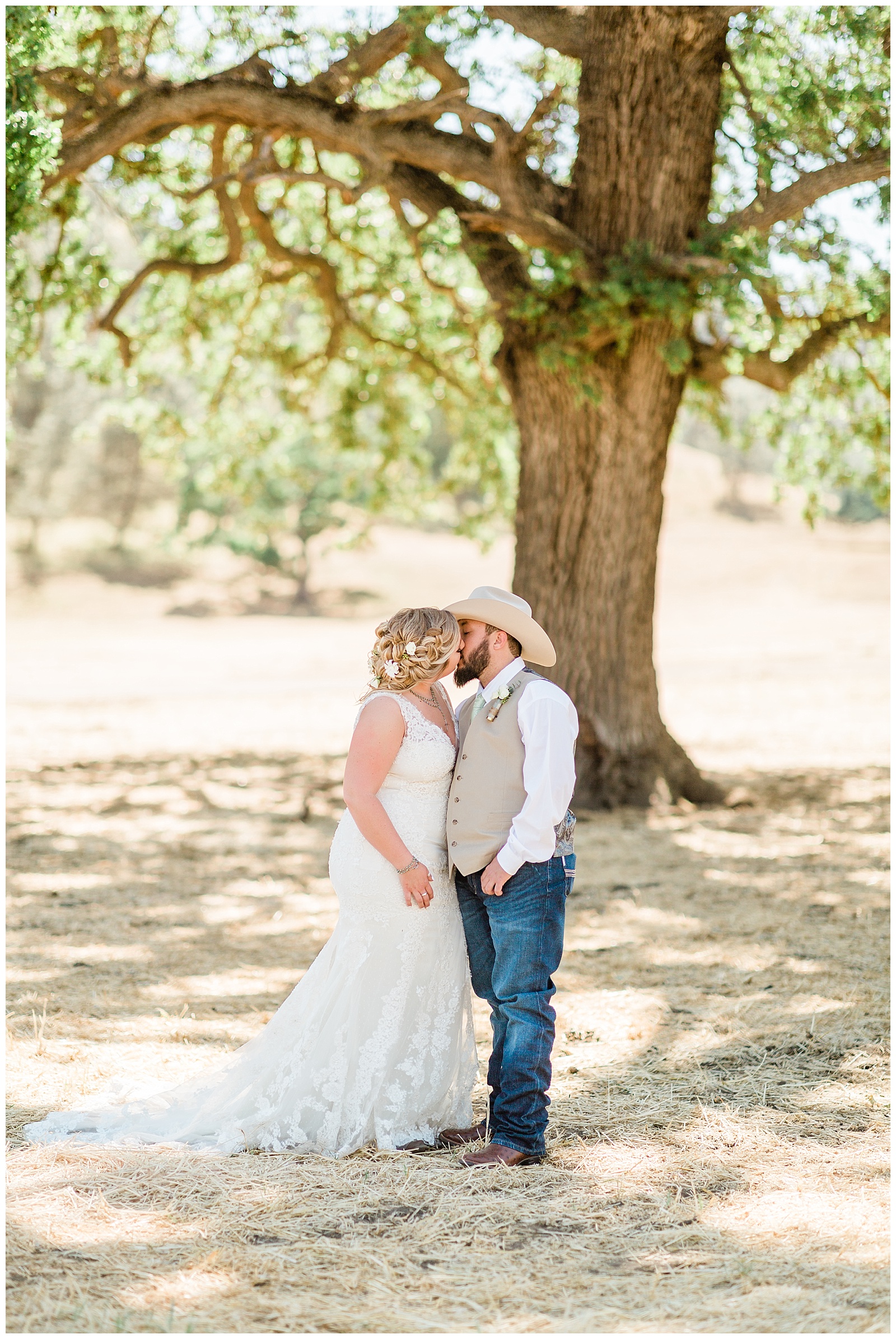 country bride and groom kissing under an oak tree at fox creek ranch