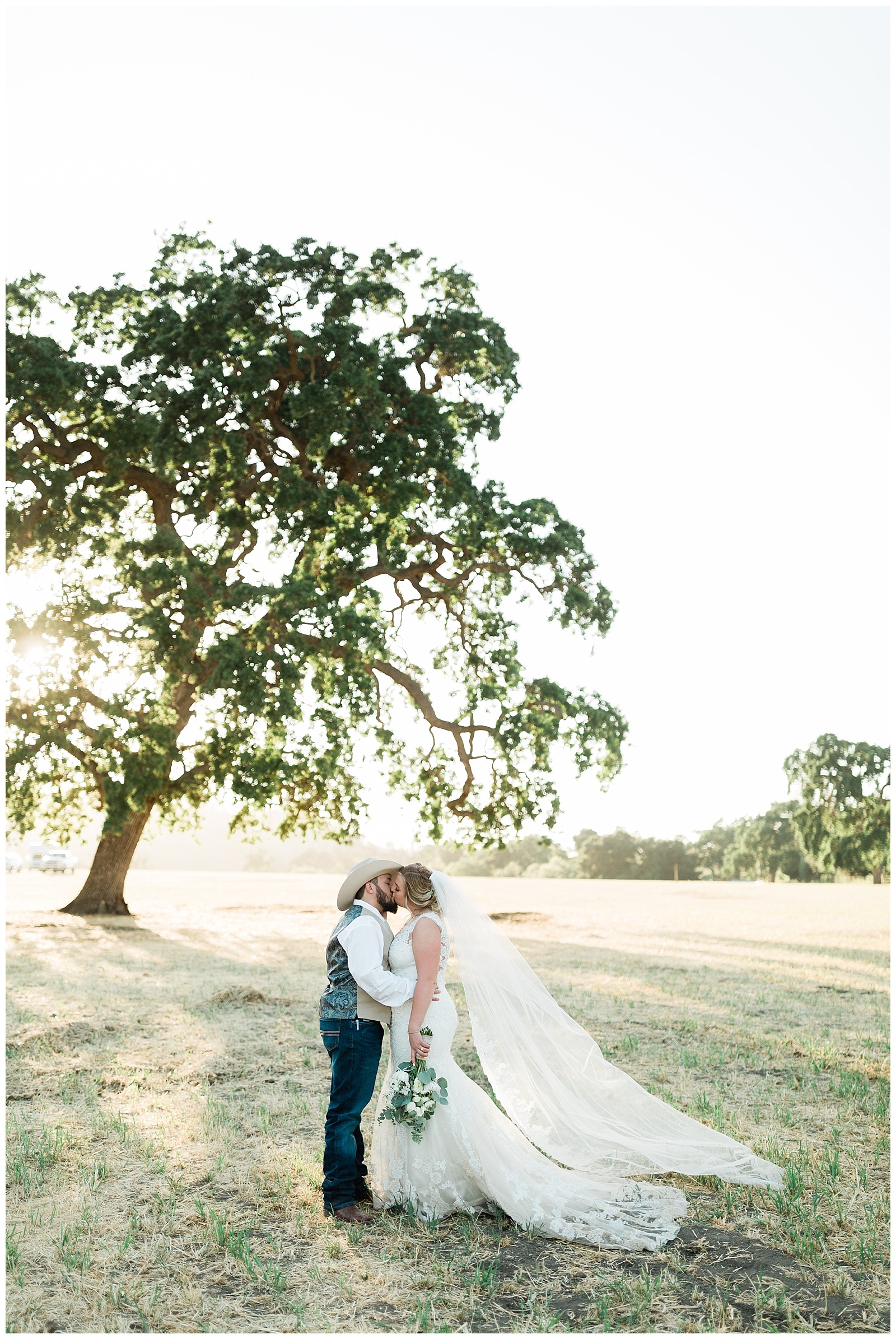 sunset wedding portraits in front of a large oak tree at fox creek ranch