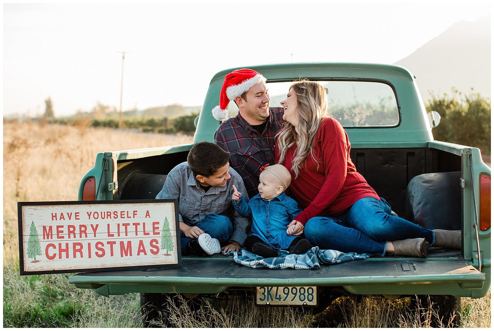 candid family christmas photos in the bed of an old green ford truck