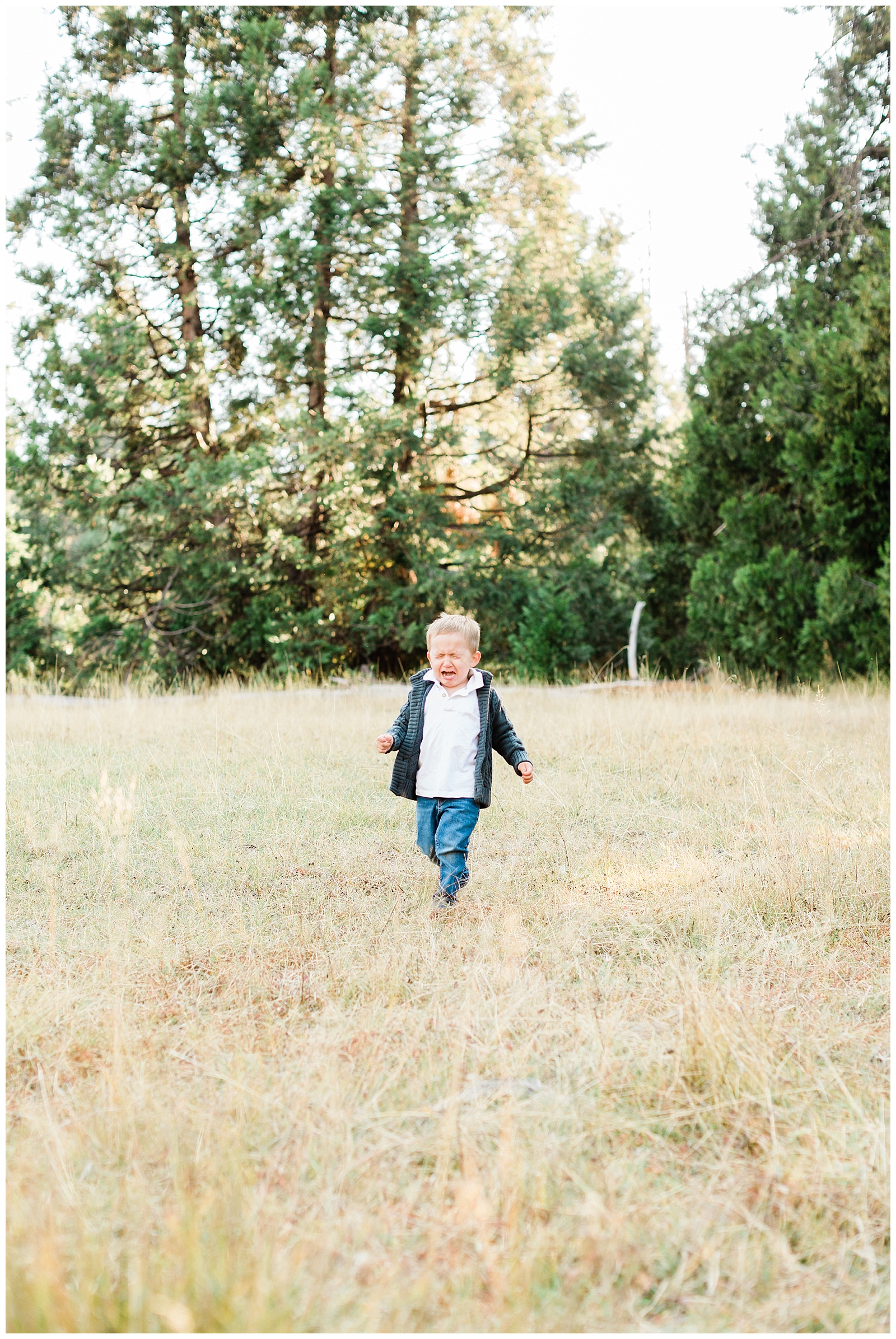 toddler running and crying in a meadow