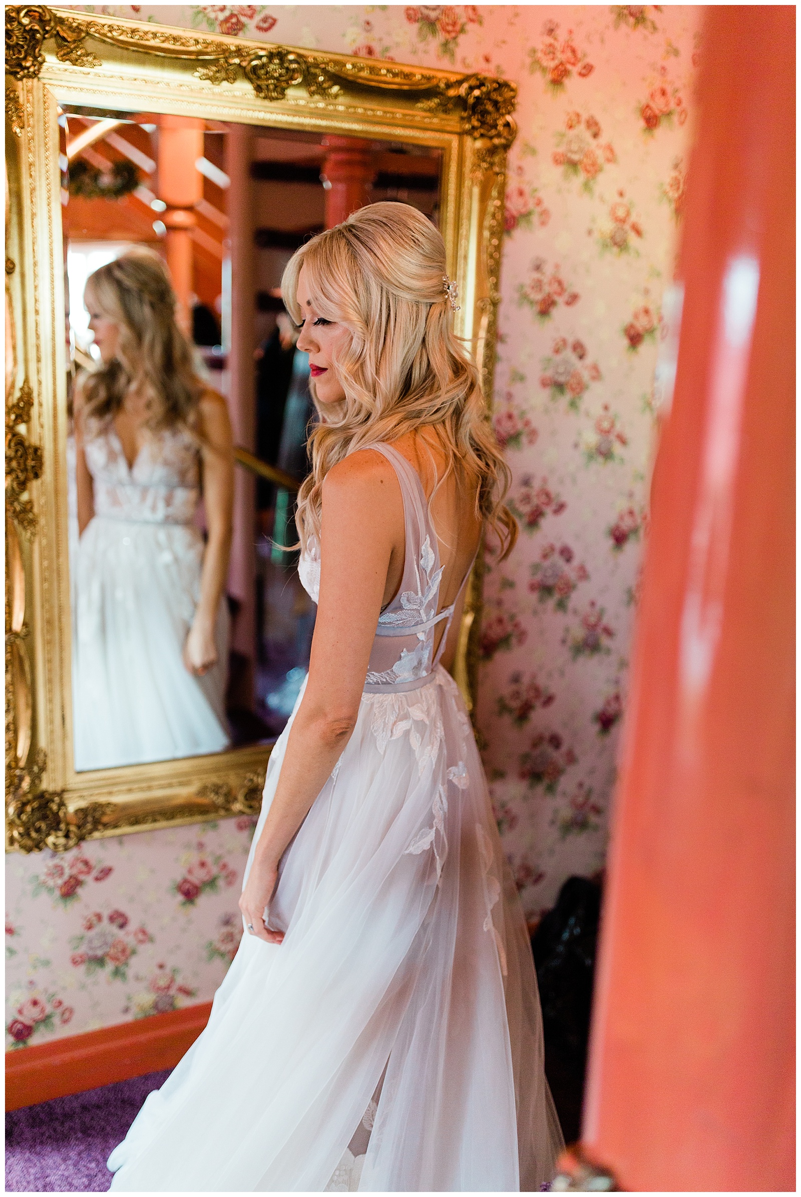 bride in a BHLDN wedding dress standing in front of a mirror
