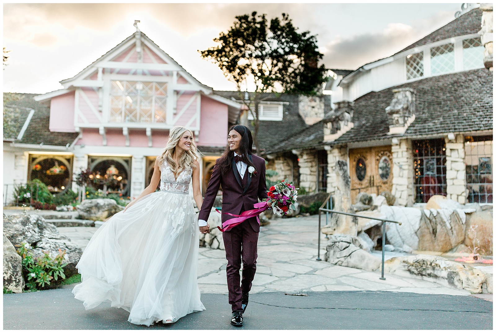 bride ad groom walking in front of the madonna inn for sunset wedding photos