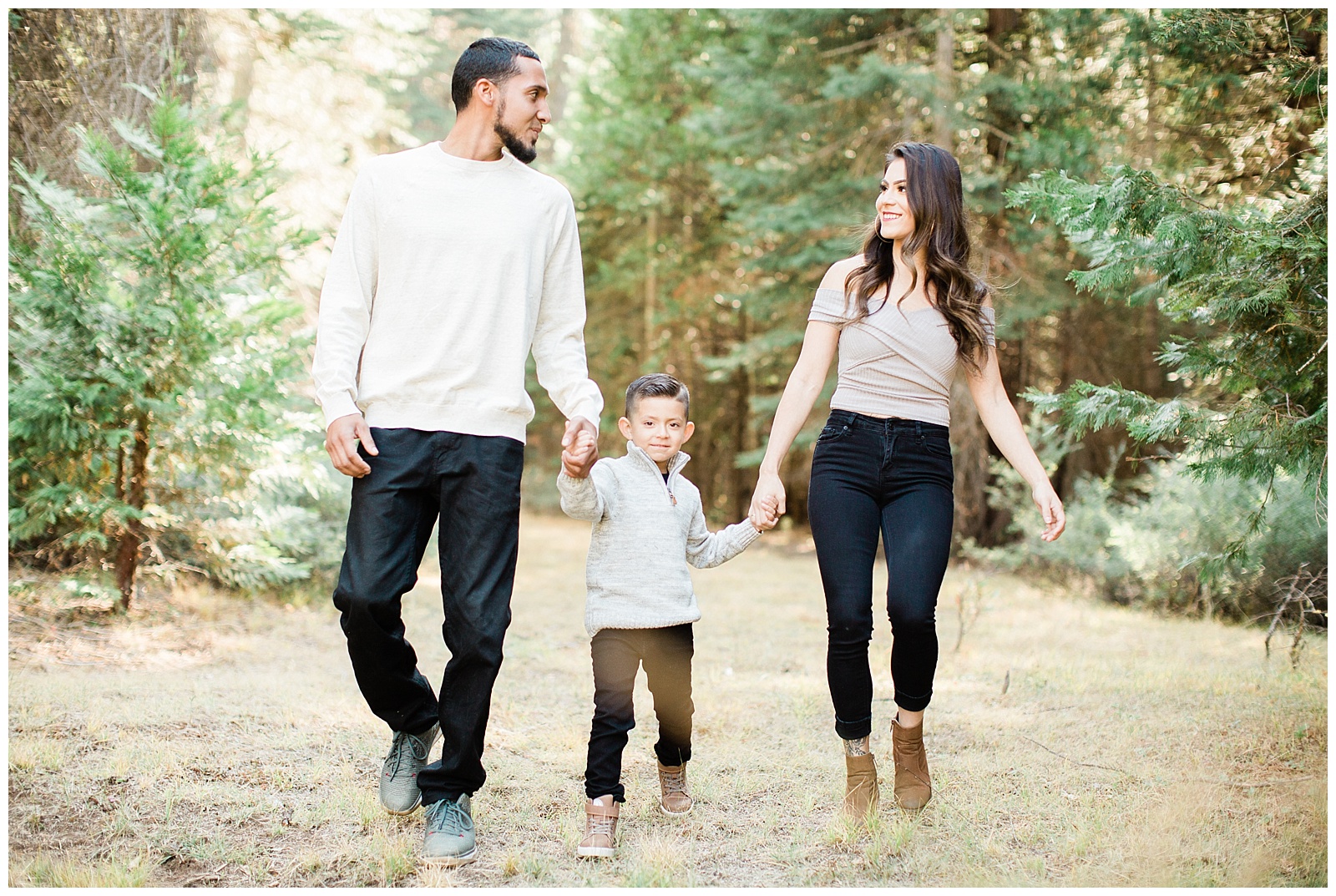 family photos walking through a green meadow