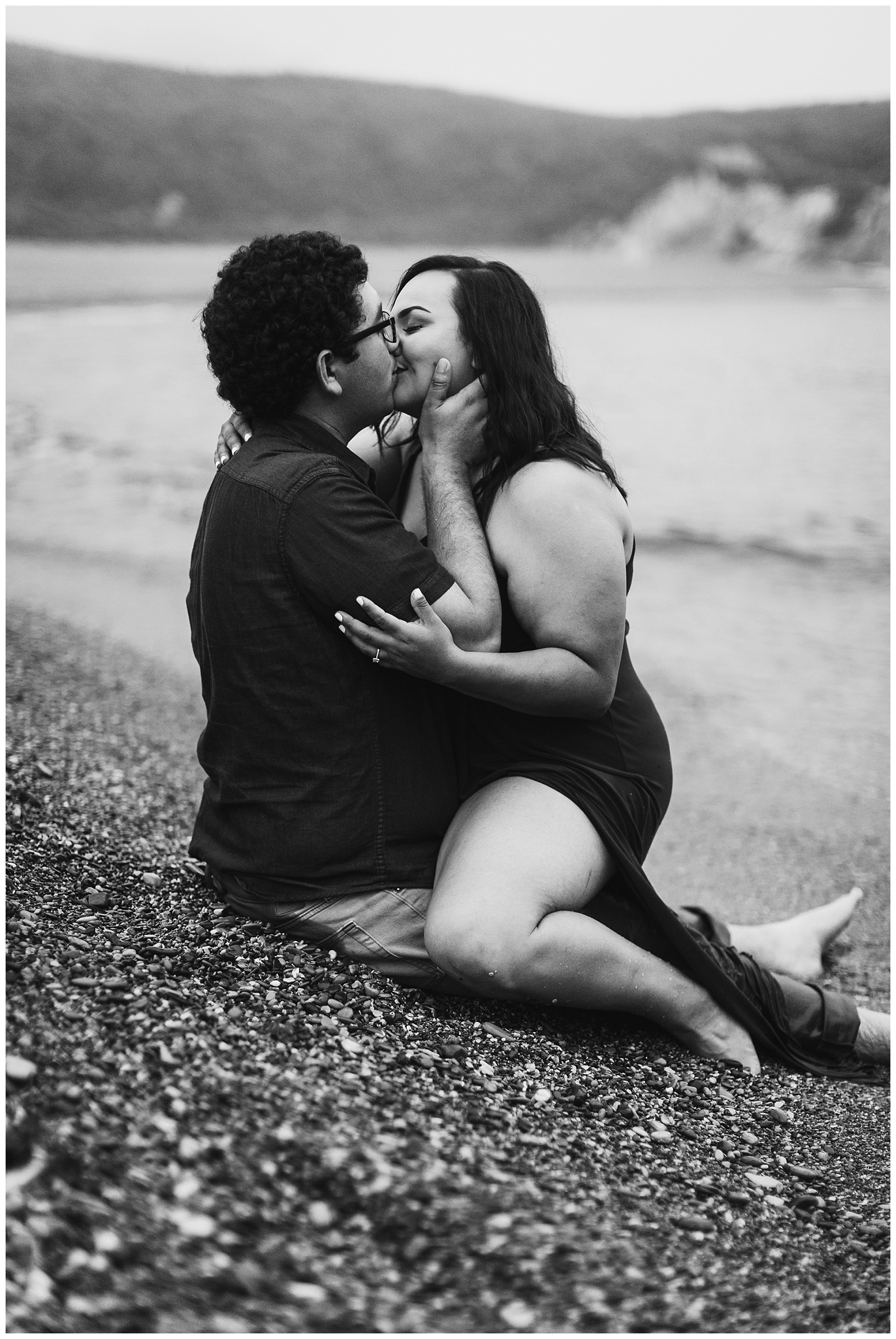 black and white photo of a couple kissing for a foggy coastal engagement session
