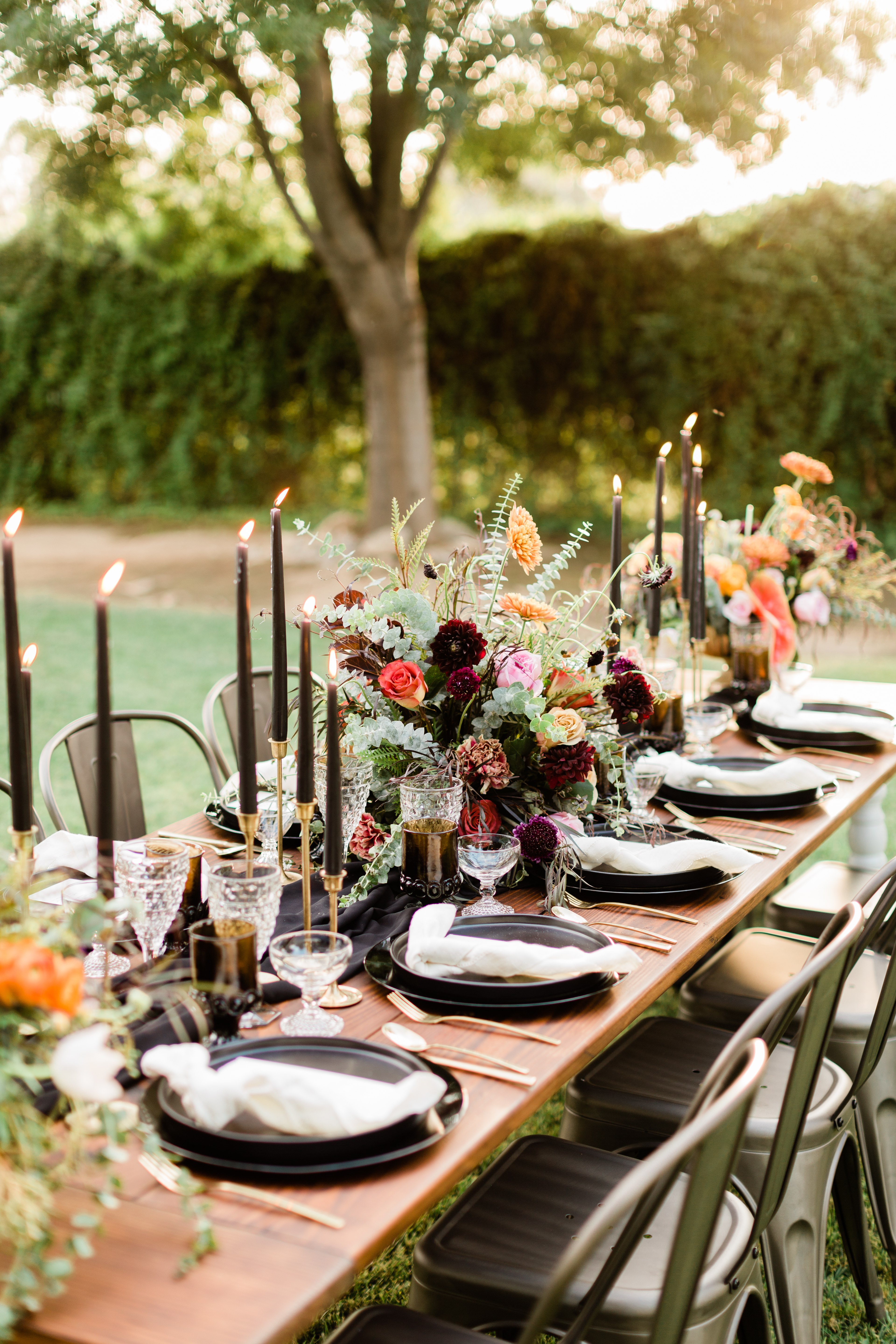 halloween wedding table decorations with black plates, gold silverware and black candles