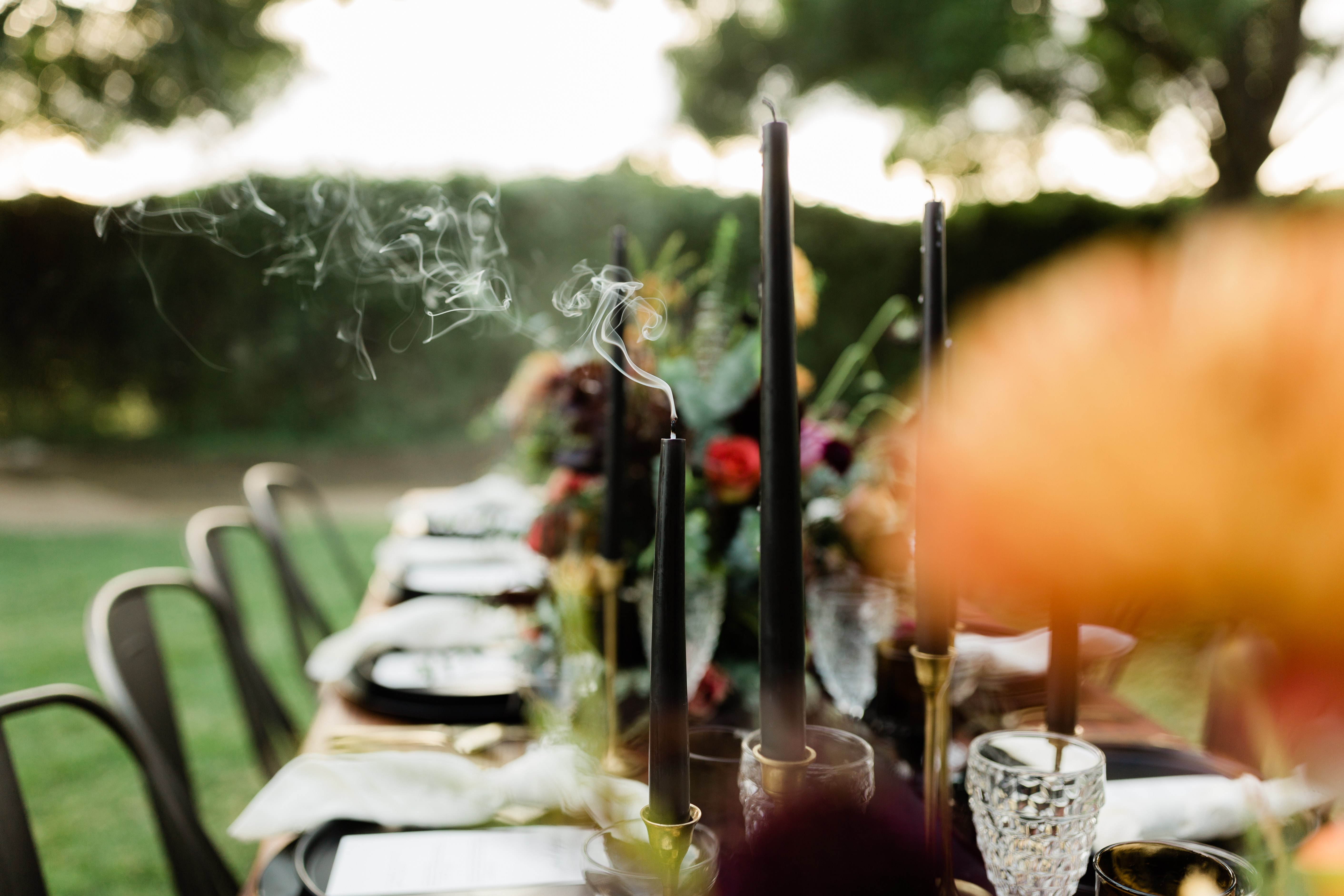 smoke coming off a black candle on a halloween wedding table setting