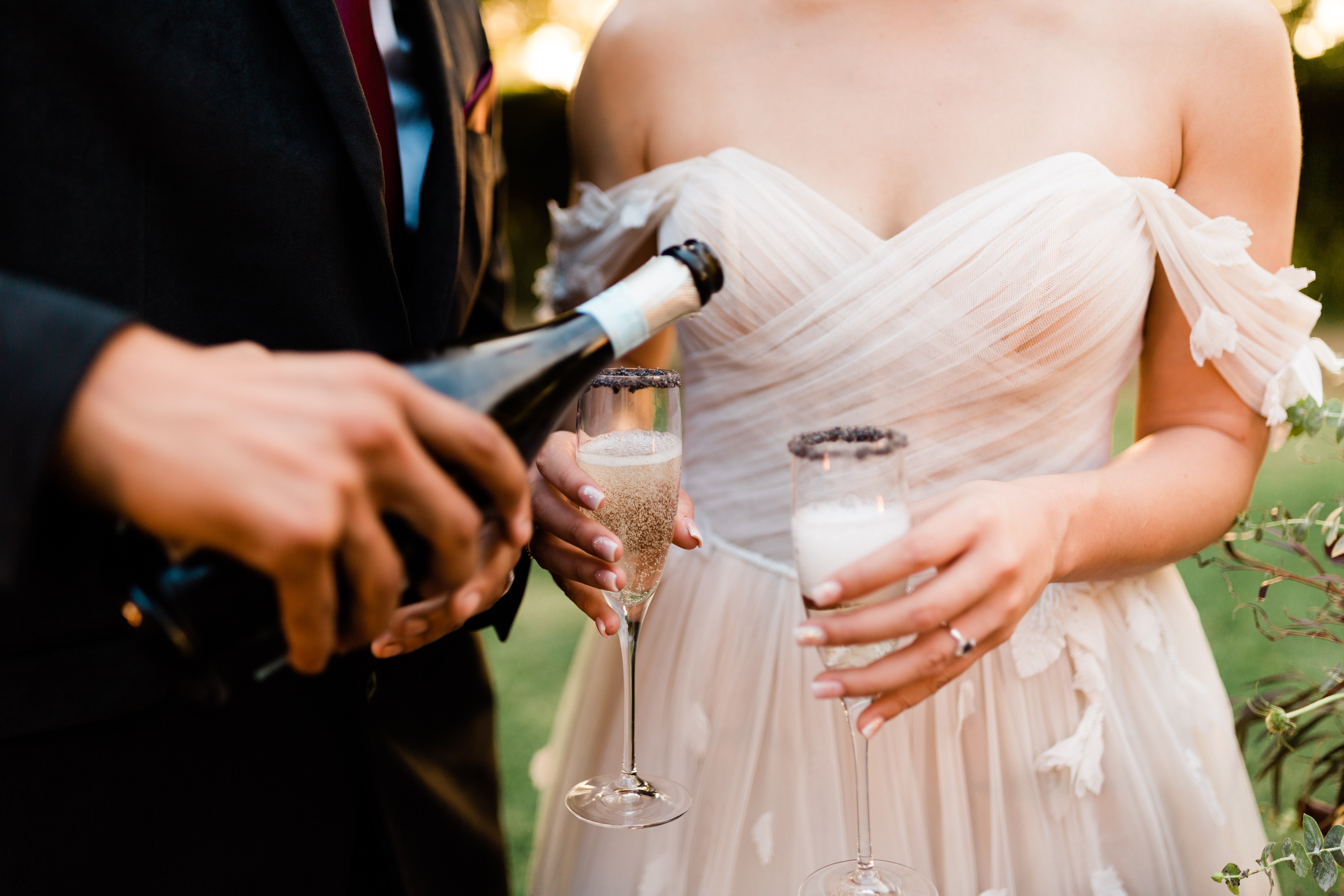 wedding couple pouring champagne
