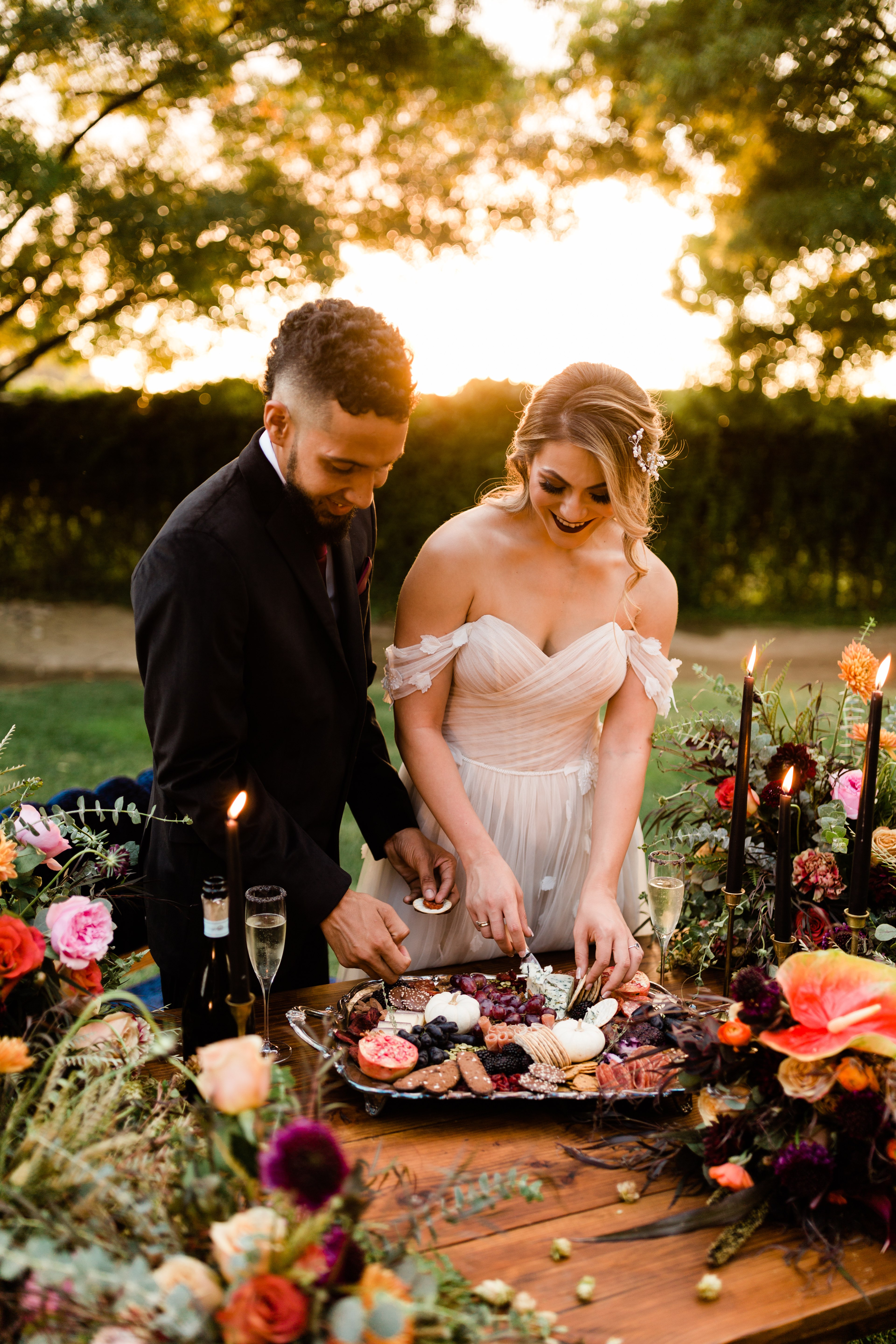 bride and groom eating charcuterie